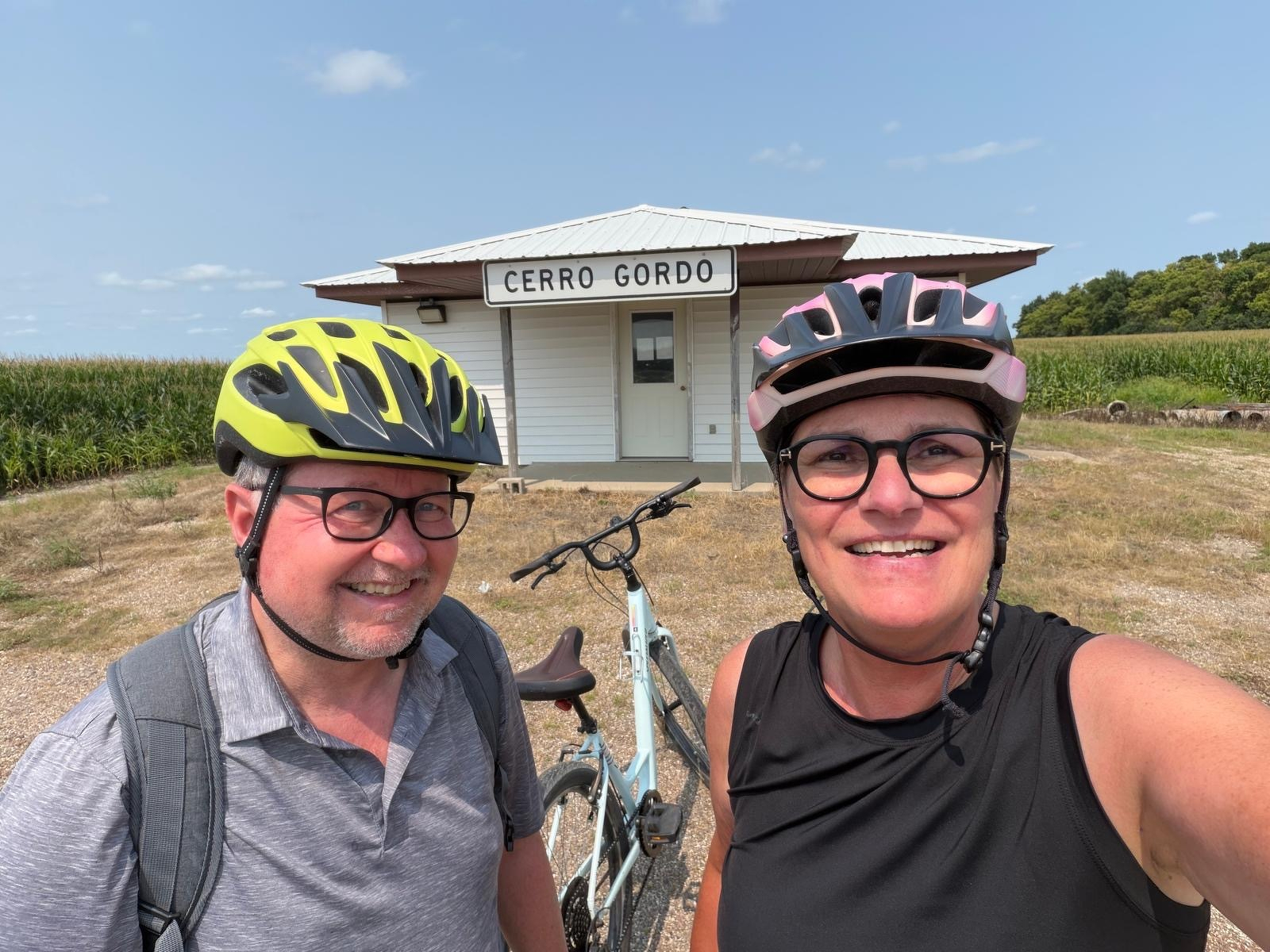 Two bicyclists standing in front of the Cerro Gordo Town Hall, Lac qui Parle County, Minnesota 