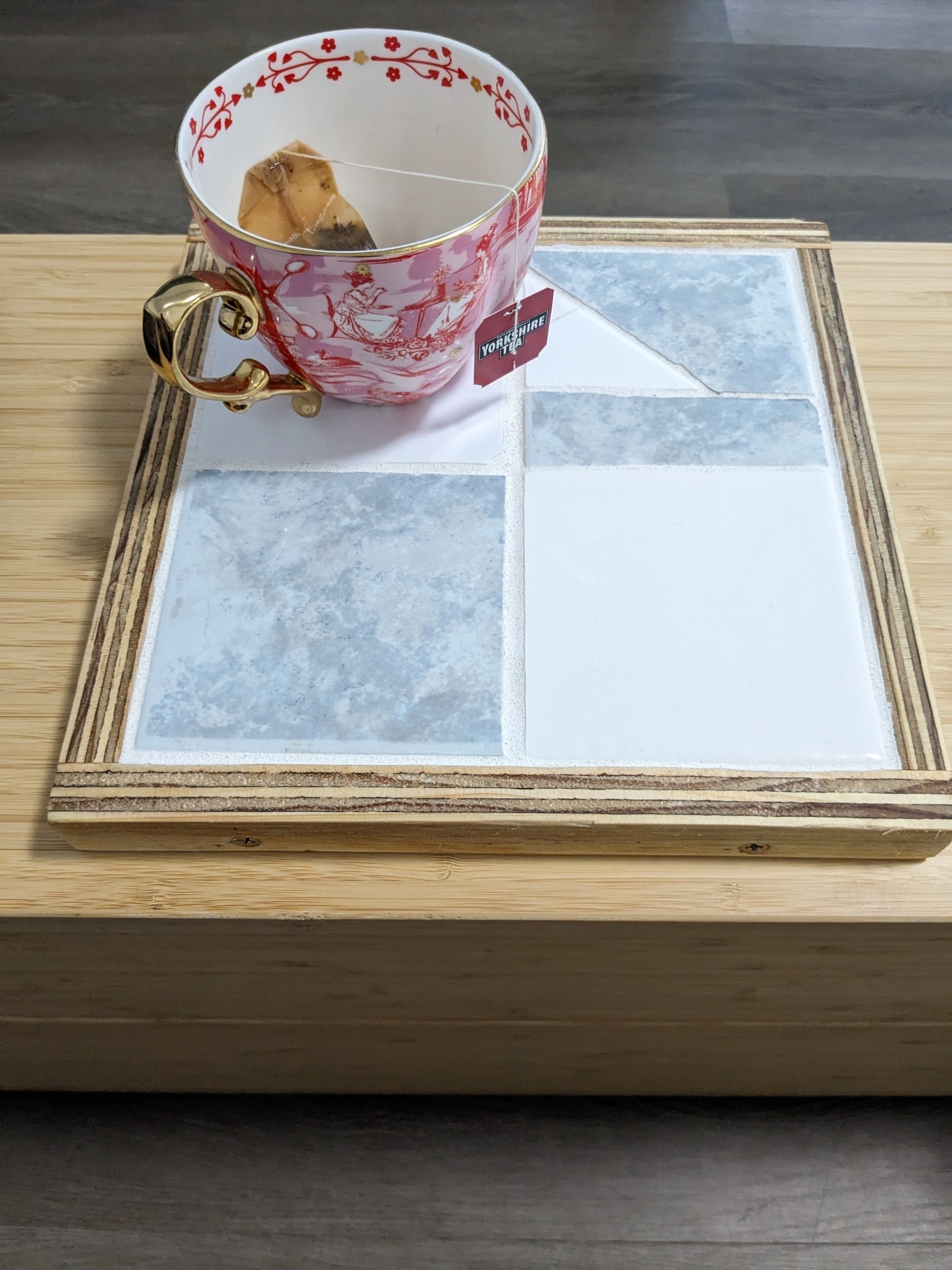 Handmade wooden and tiled coaster! Has a pink oversized teacup on it. 