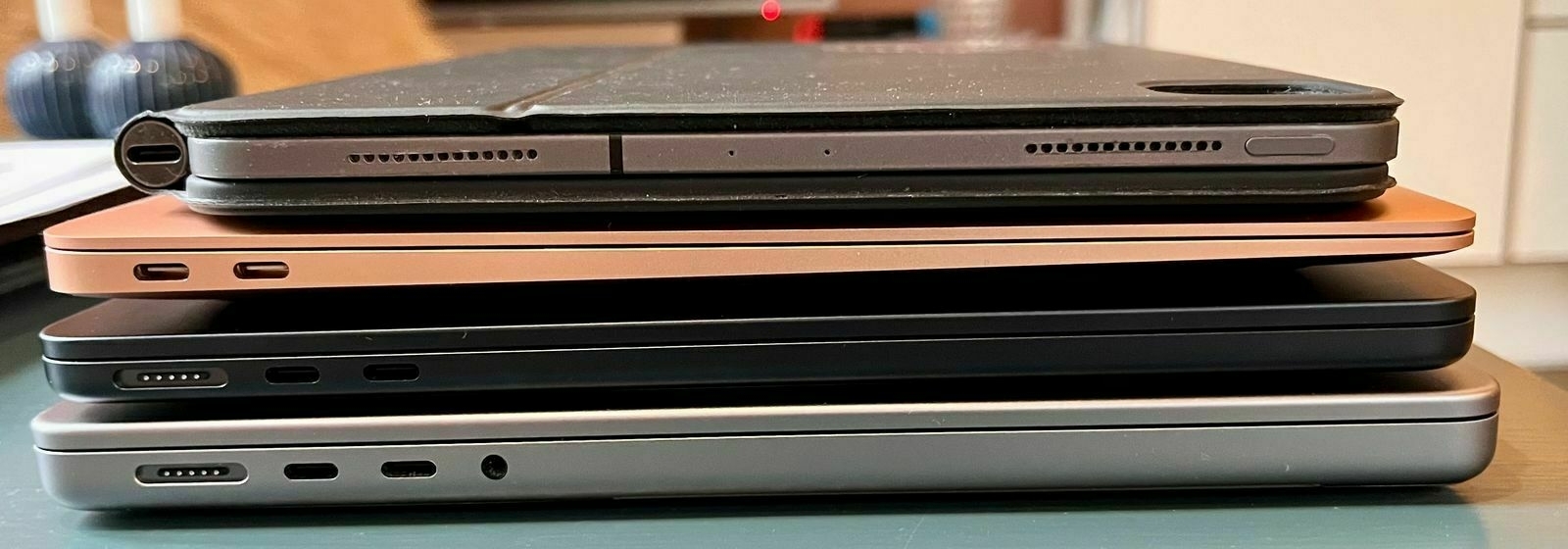 From top to bottom: iPad Pro 11-inch with Magic Keyboard, M1 MacBook Air, M2 Macbook Air, 14-inch MacBook Pro.