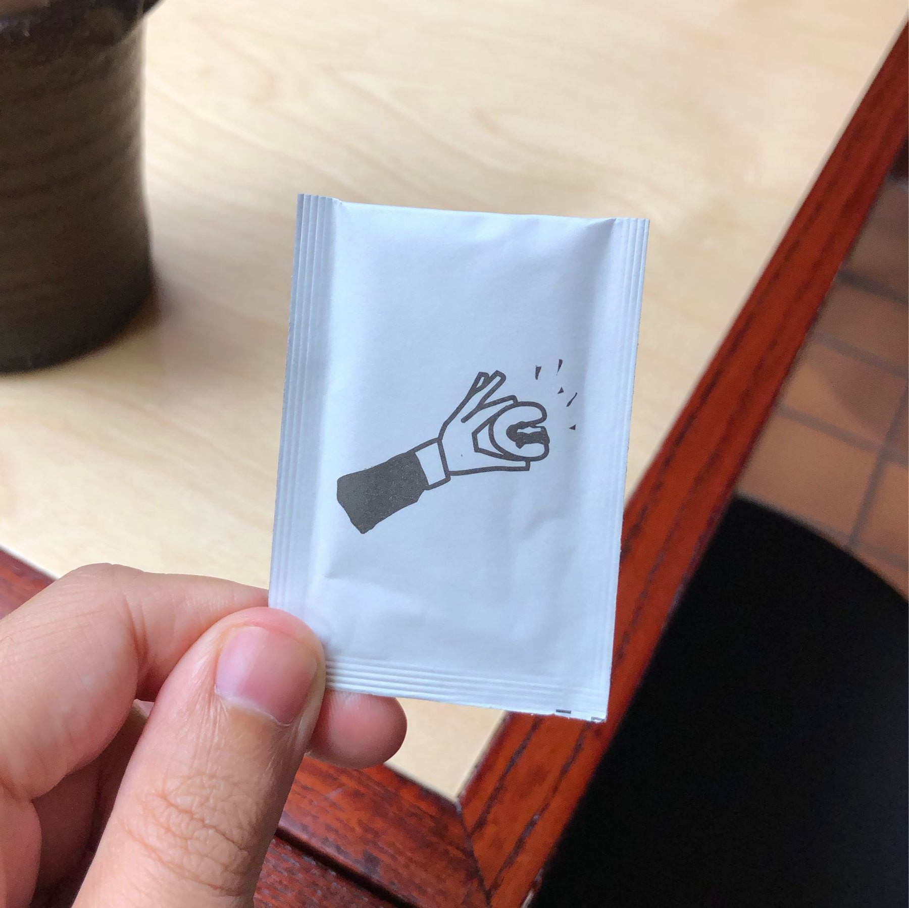 Illustration of the hand wipes with a hand holding a bun.