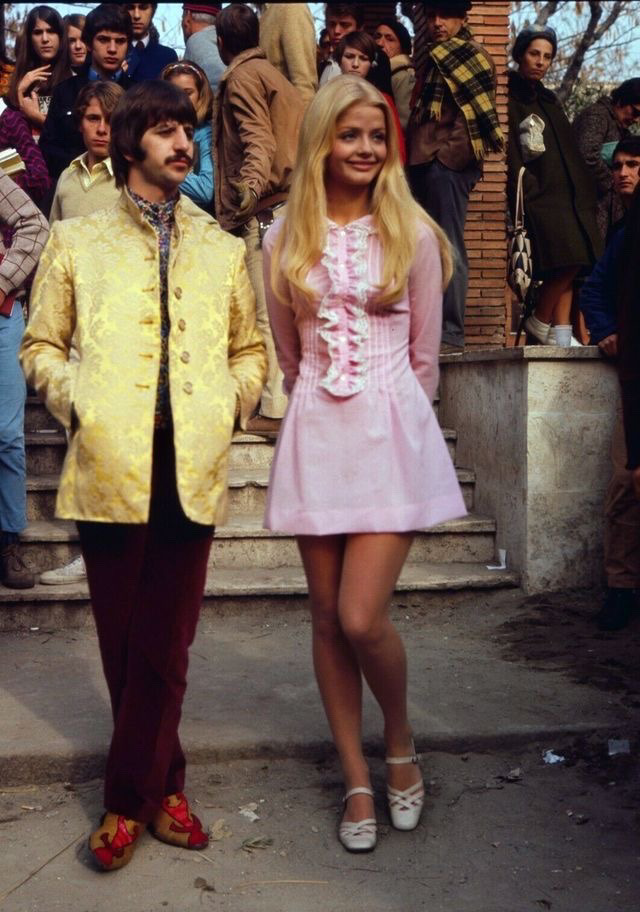 Looks like a photo of Ringo Starr and a pretty young blonde woman dressed very groovy, ca. 1970