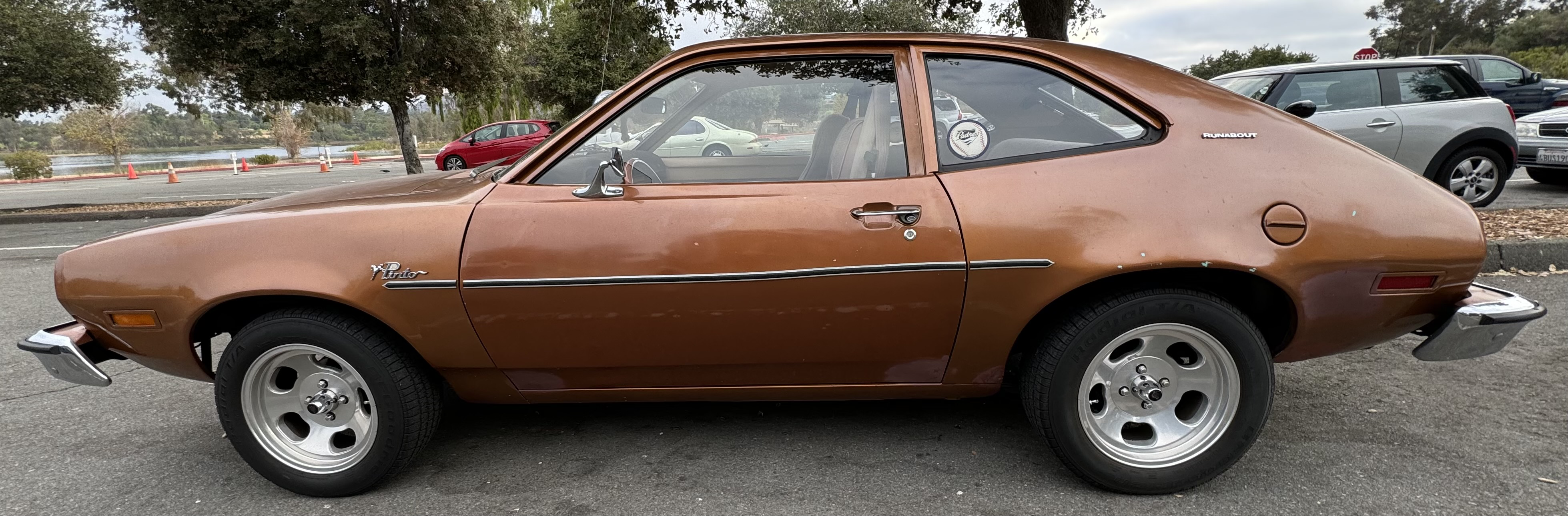 A brown Ford Pinto car, parked