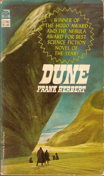 Cover of Frank Herbert’s novel “Dune,” featuring large sand dunes and a group of figures in a desert landscape, with text announcing it as the winner of the Hugo and Nebula awards for best science fiction novel of the year.