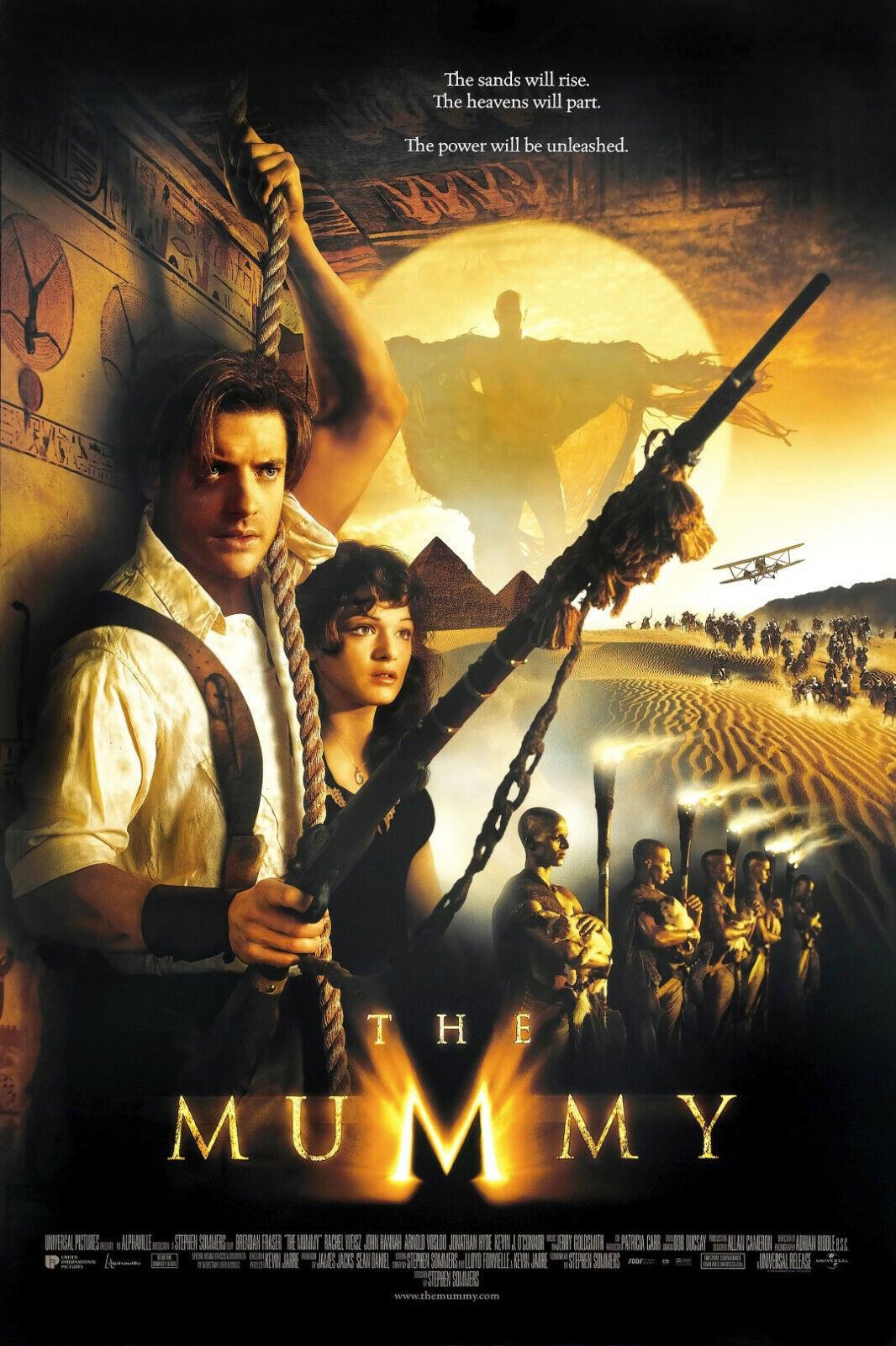 Movie poster for “The Mummy” featuring Brendan Fraser and Rachel Weiss in costume in the foreground, Egyptian imagery, and an ancient-looking figure with an army behind them. The text includes the tagline “The sands will rise. The heavens will part.”