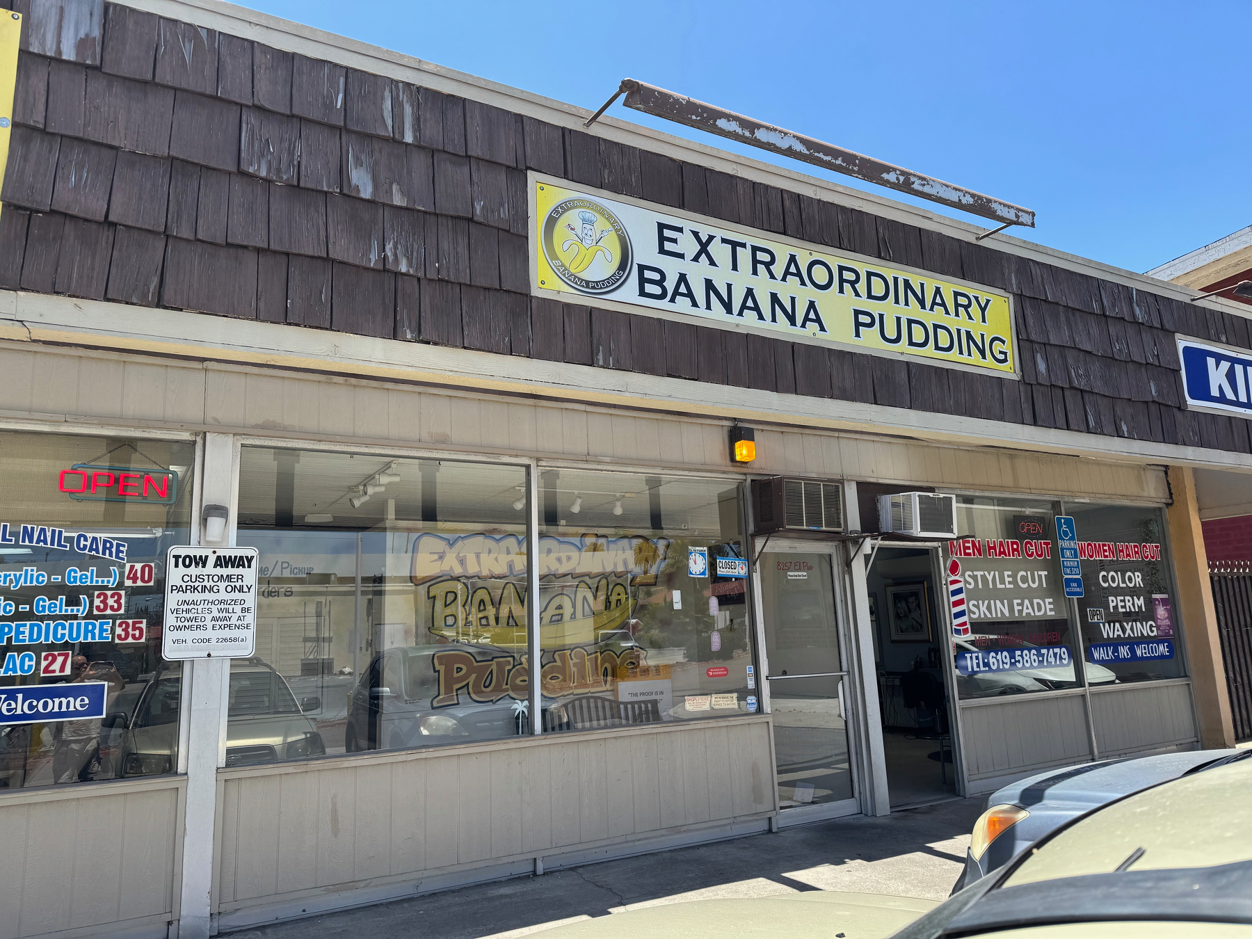 A storefront features a sign advertising Extraordinary Banana Pudding.