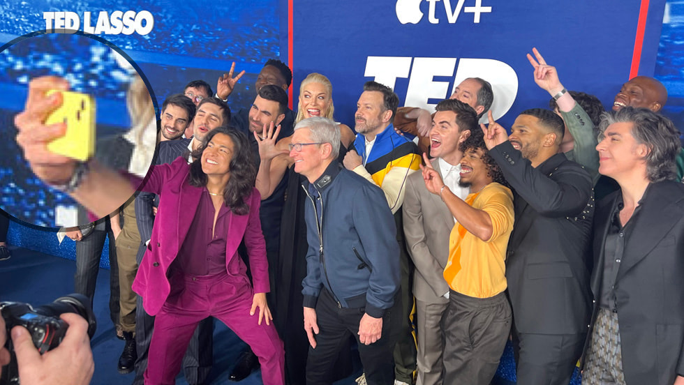 Ted Lasso cast taking a selfie with a yellow iPhone 14.