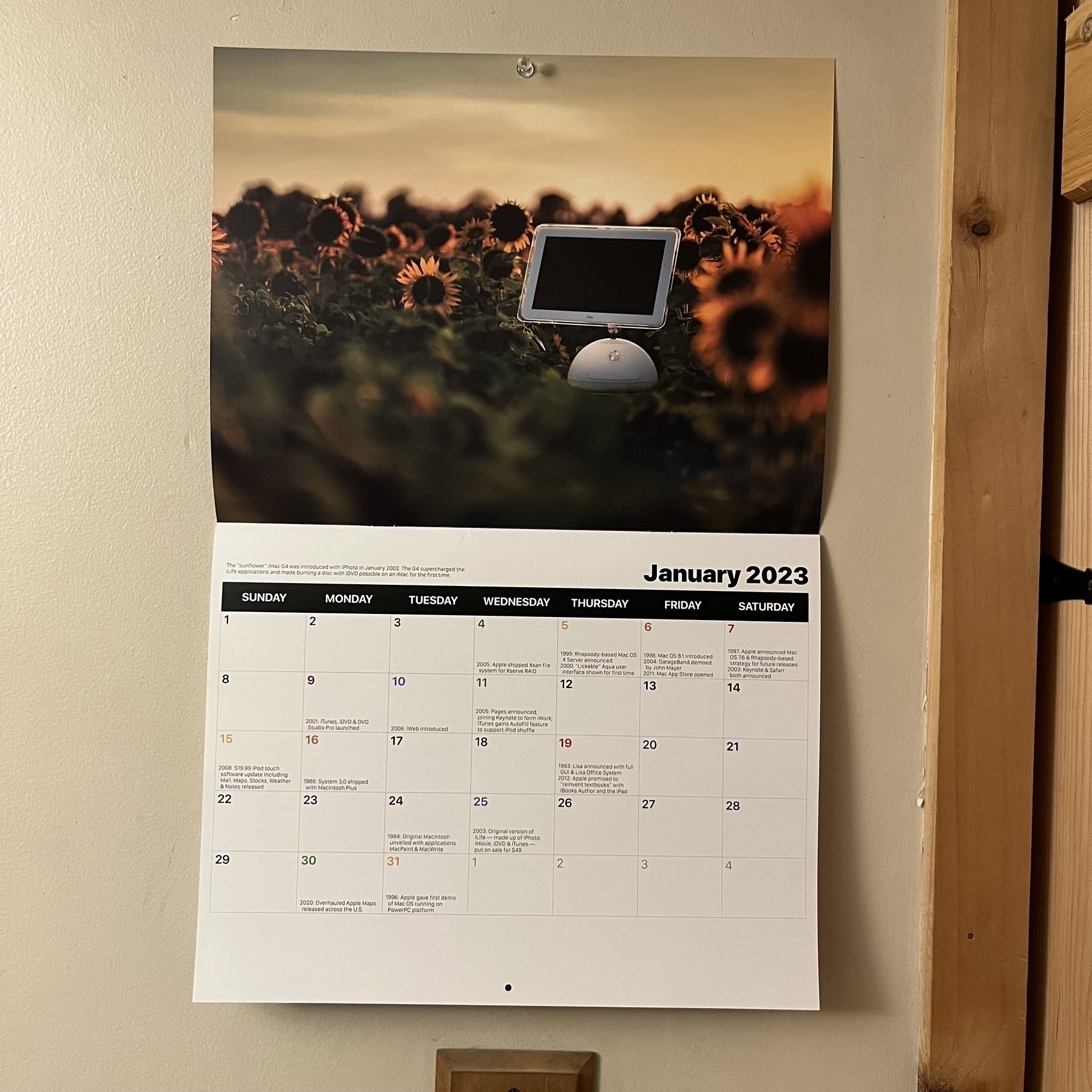 A calendar with a iMac G3 in a field of sunflowers as the featured image.