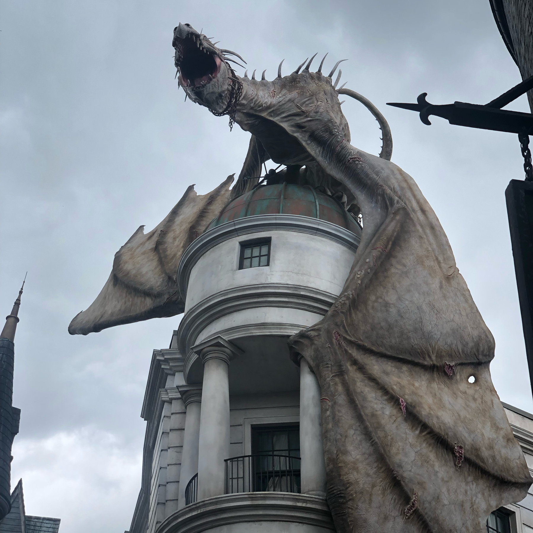 A dragon atop a columned porch.