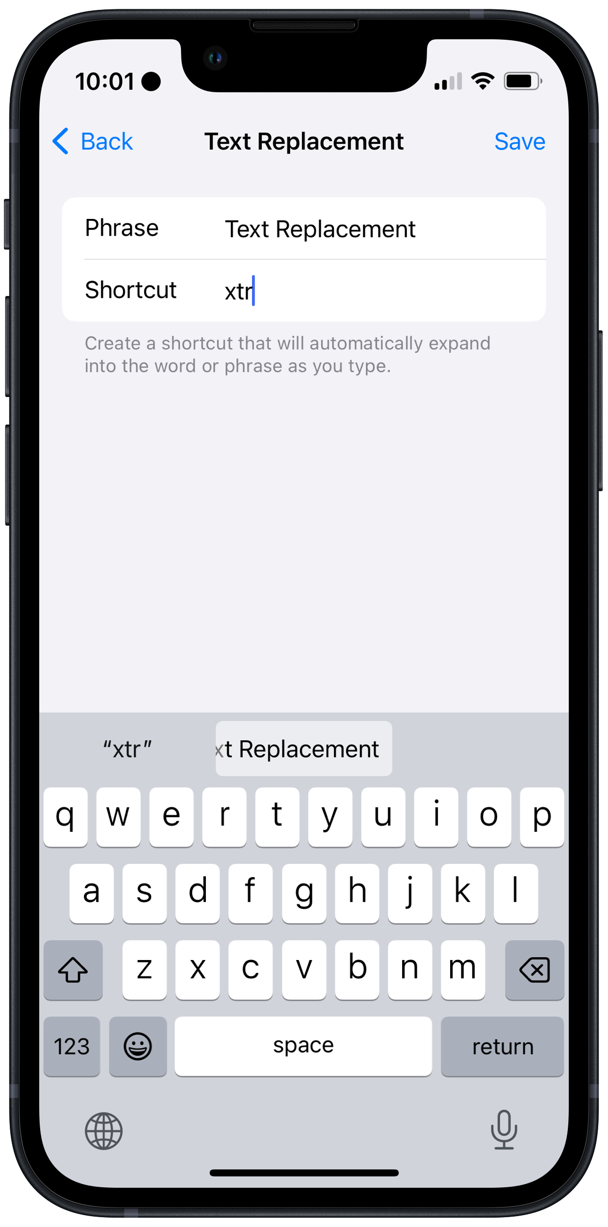 iPhone screenshot of the Text Replacements screen in which the replacement I was creating is already suggested in the QuickType keyboard suggestions.