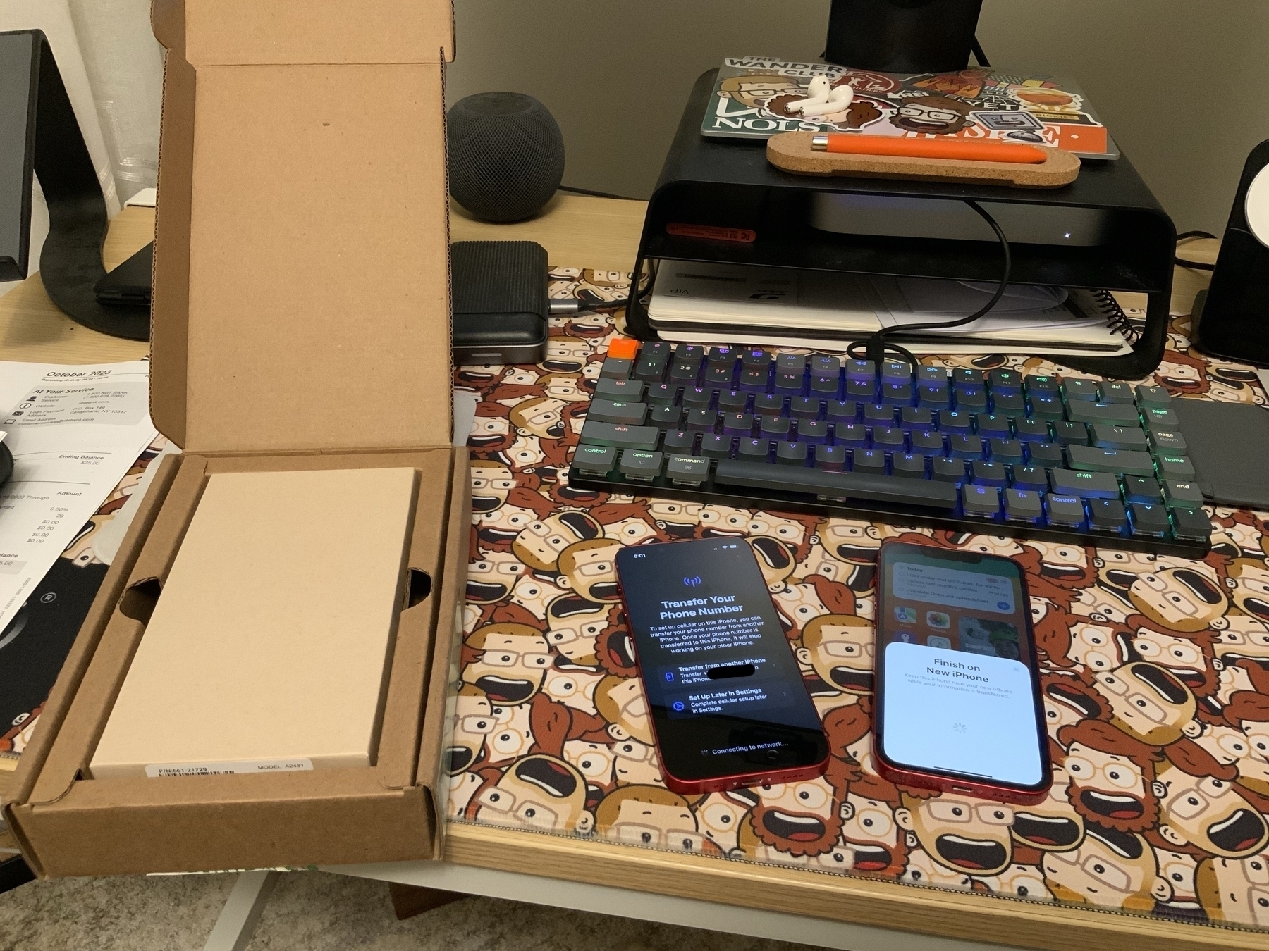 Two iPhones on a desk showing setup screens.