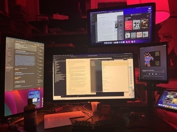 Monitors in a darkened, red-glowing room.