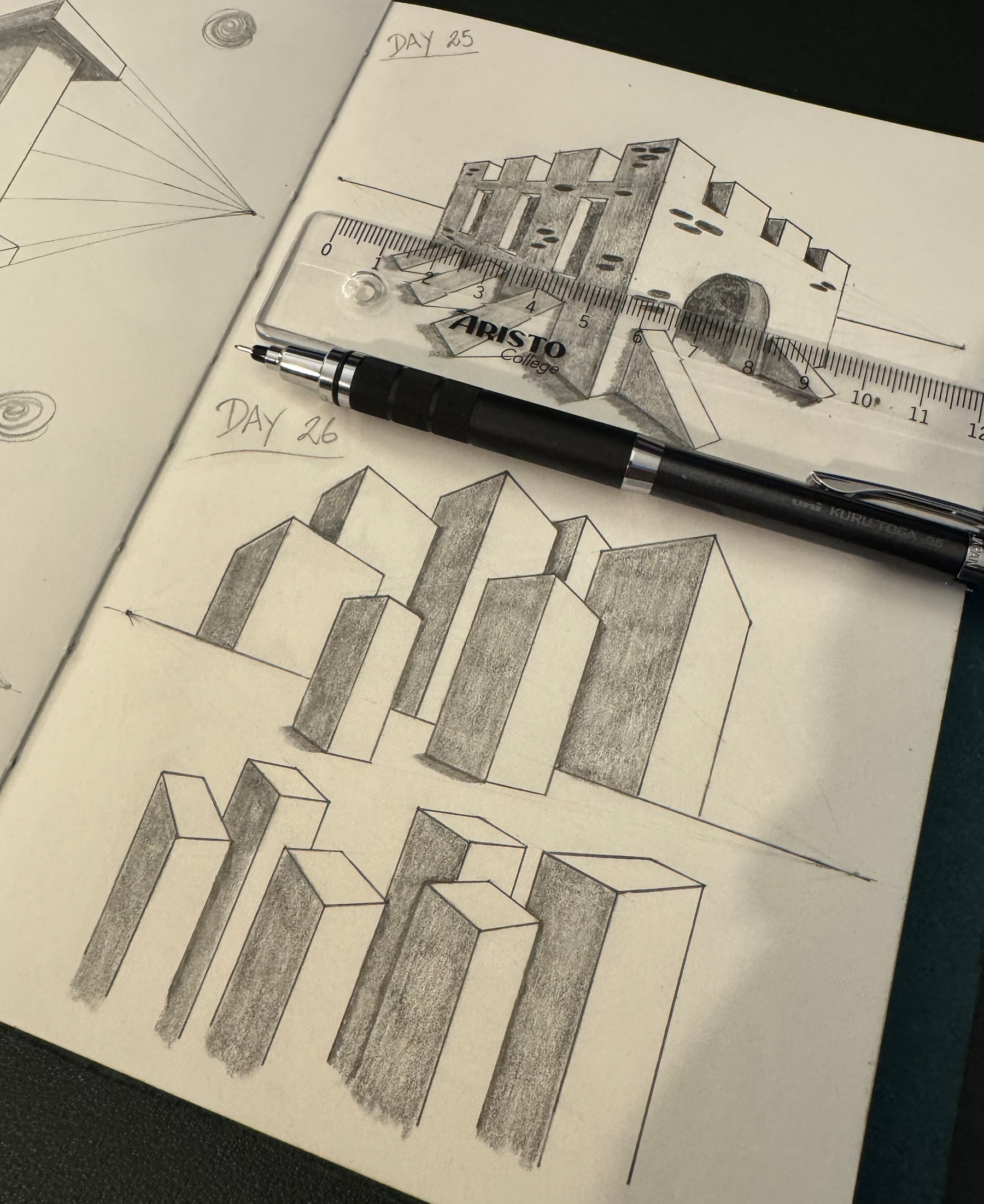 A sketchbook displays pencil drawings of geometric forms and architectural elements, with DAY 25 showing a building and DAY 26 featuring an arrangement of block-like structures, accompanied by a pen.