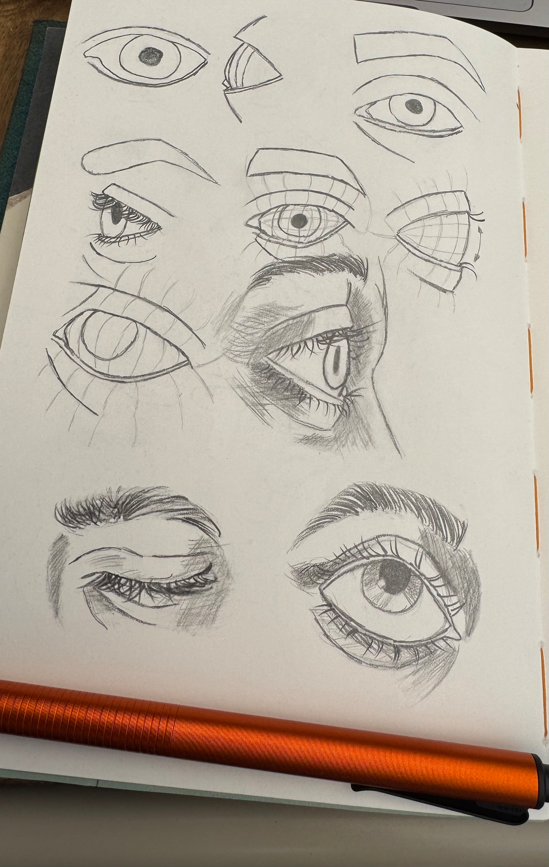 A sketchbook page features various pencil sketches of eyes, some with detailed shading and others showing construction lines.