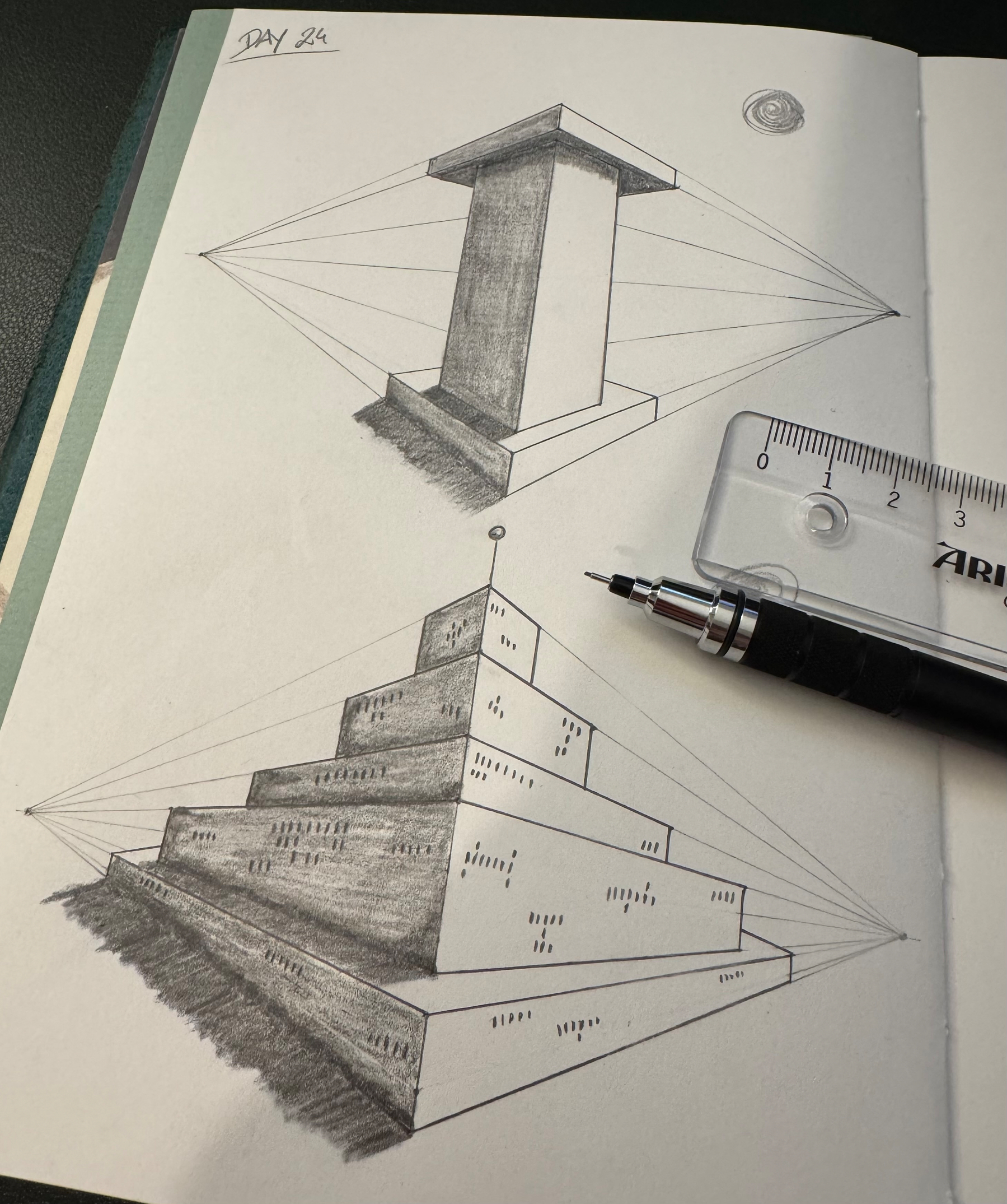 Two geometric architectural sketches with perspective lines, featuring a tall rectangular pillar and a stepped pyramid structure, are shown on a sketchbook page alongside a pencil and a ruler.