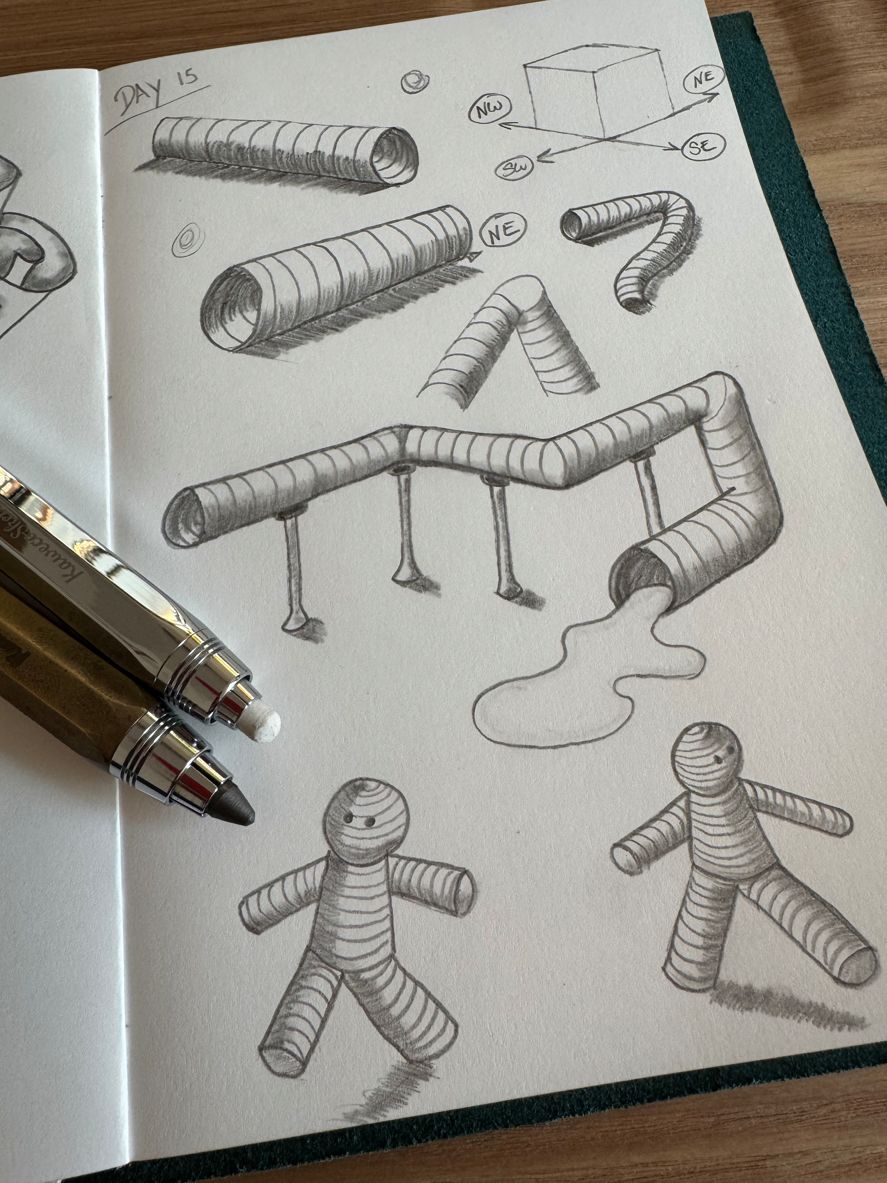Pencil sketches of various segmented, coiled tube-like creatures and structures resemble playful, flexible forms, accompanied by two mechanical pencils on the side.