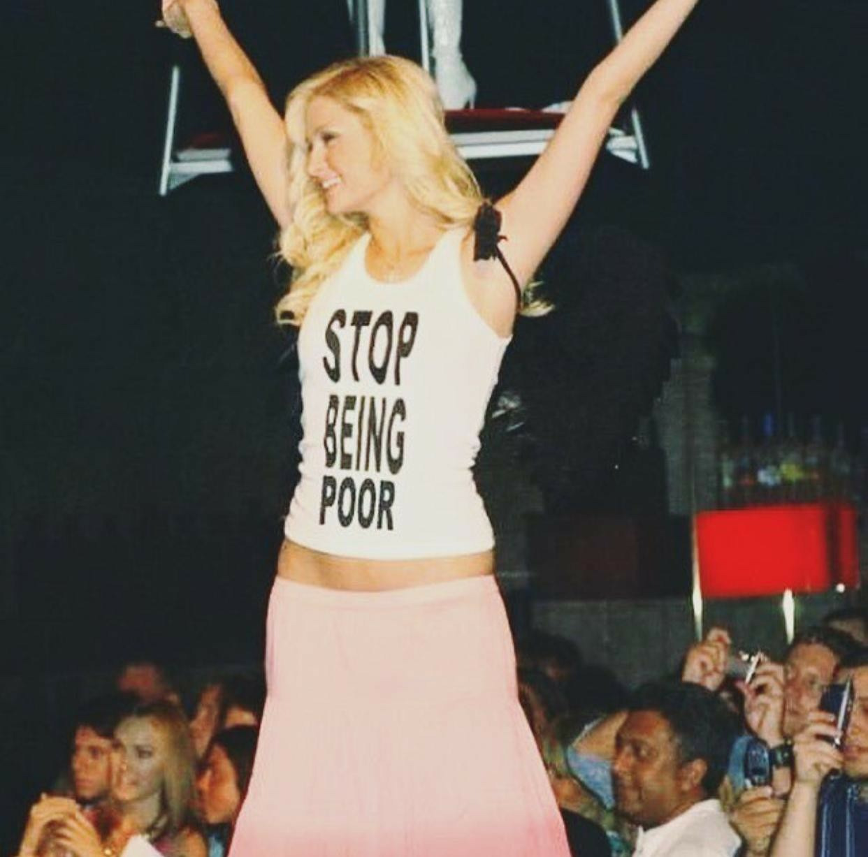 Paris Hilton weraring a Stop Being Poor shirt