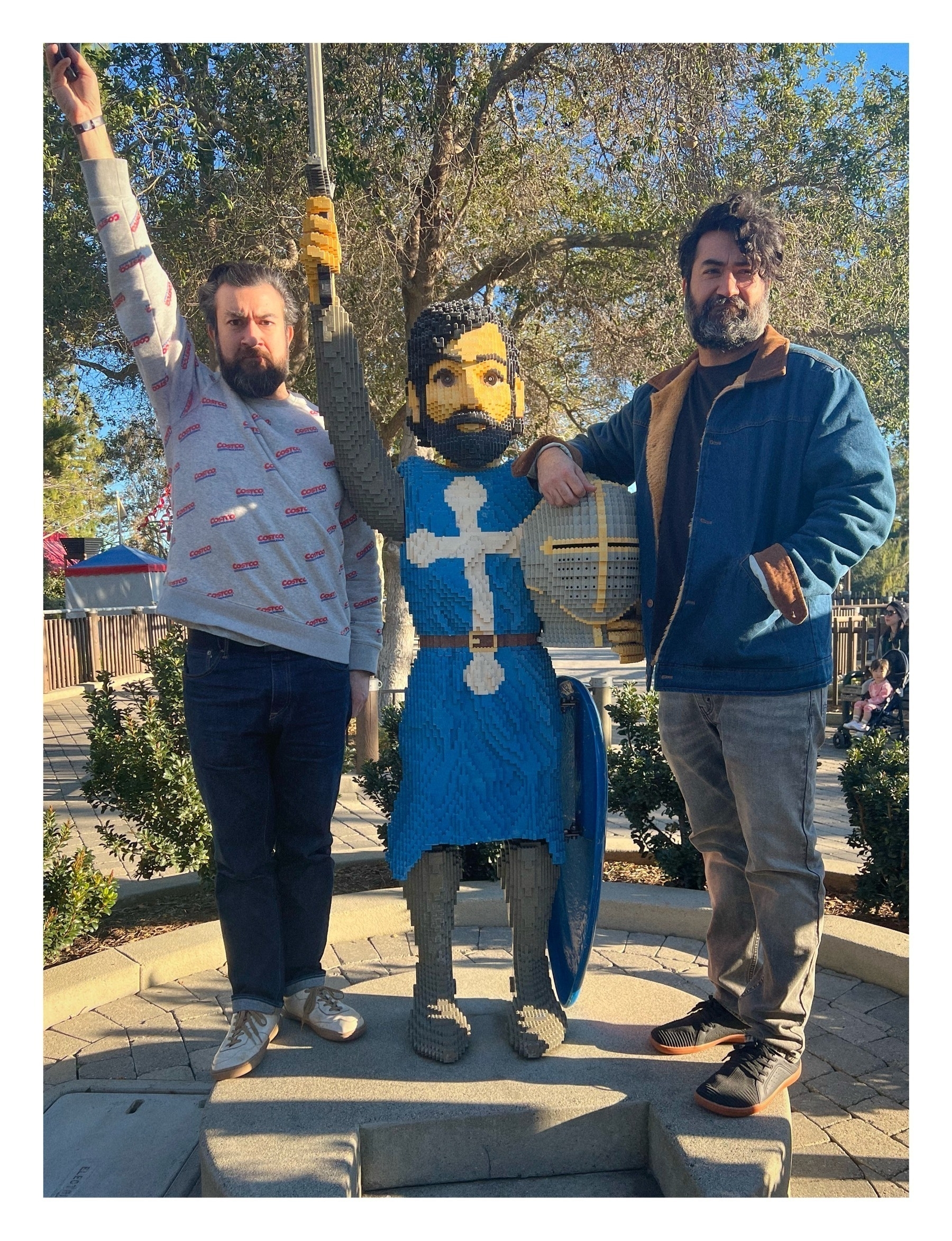 My brother and I standing next to a LEGOLAND knight that has similar hair, beard, and coloring to us. 