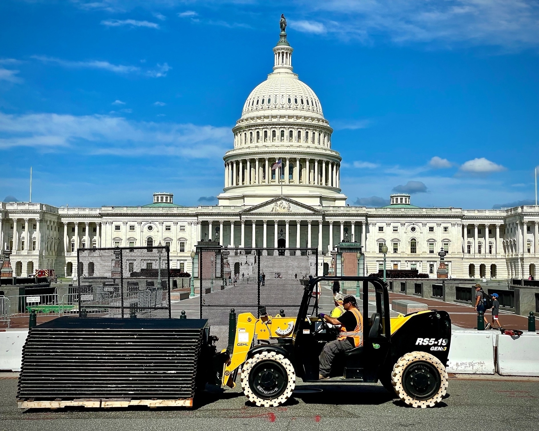 A forklift moved a pallent of disassembled fence segments in front of the US Capitol
