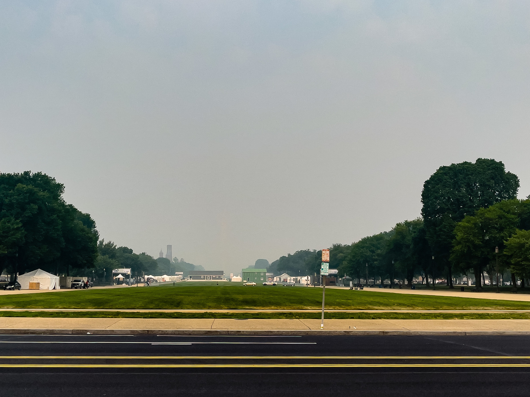 A photograph of the National Mall, facing West from Third Street NW. The Washington Monument, usually dominating this view is almost imperceptible in the haze. 