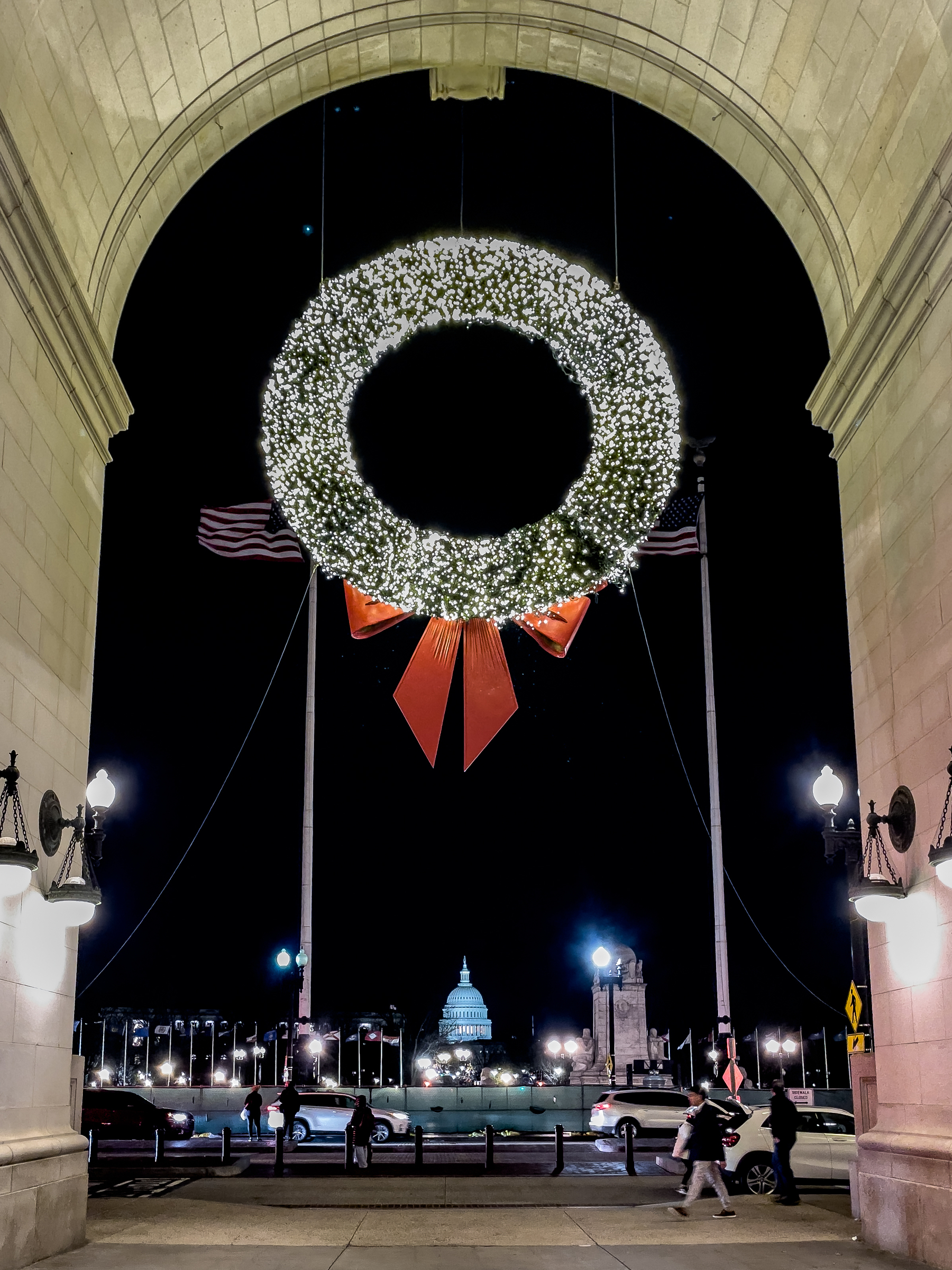 One of the large lit wreaths hanging in an entrance archway of Washington’s Union Station. The U.S. Capitol Dome is visible in the background. 