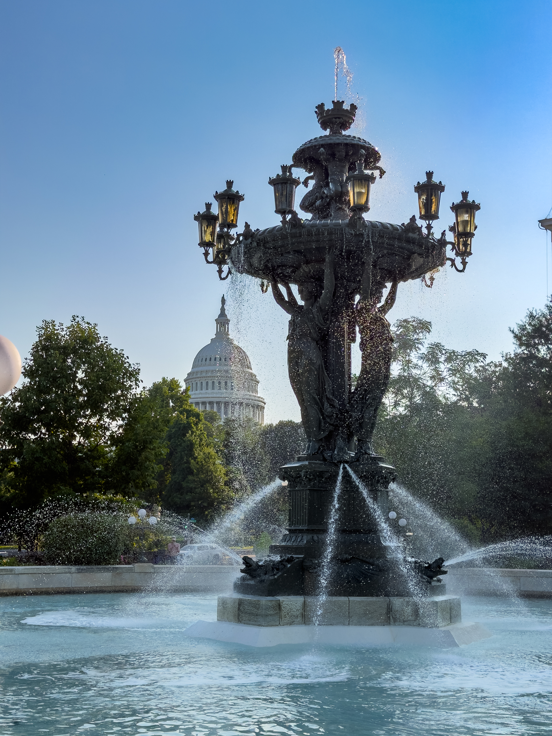 A view of the U.S. Capitol Dome looming behind the Bartholdi Fountain on the grounds of the U.S. Botanic Gardens.