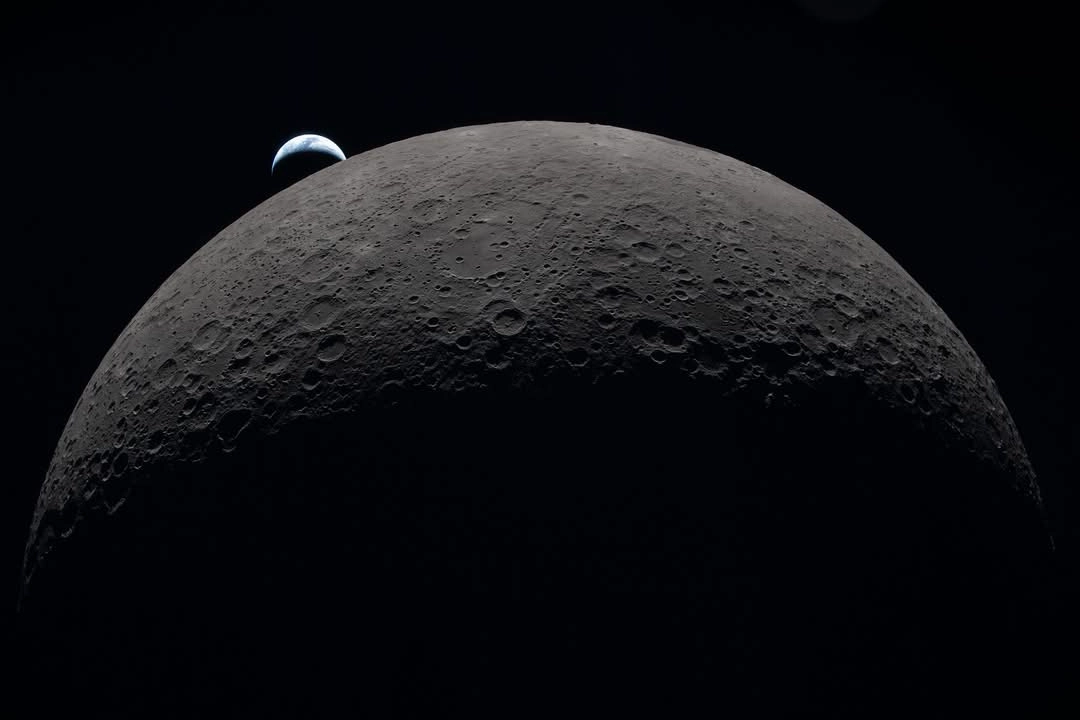 Auto-generated description: A view of the moon&rsquo;s rocky surface is shown with the Earth appearing in the distance.