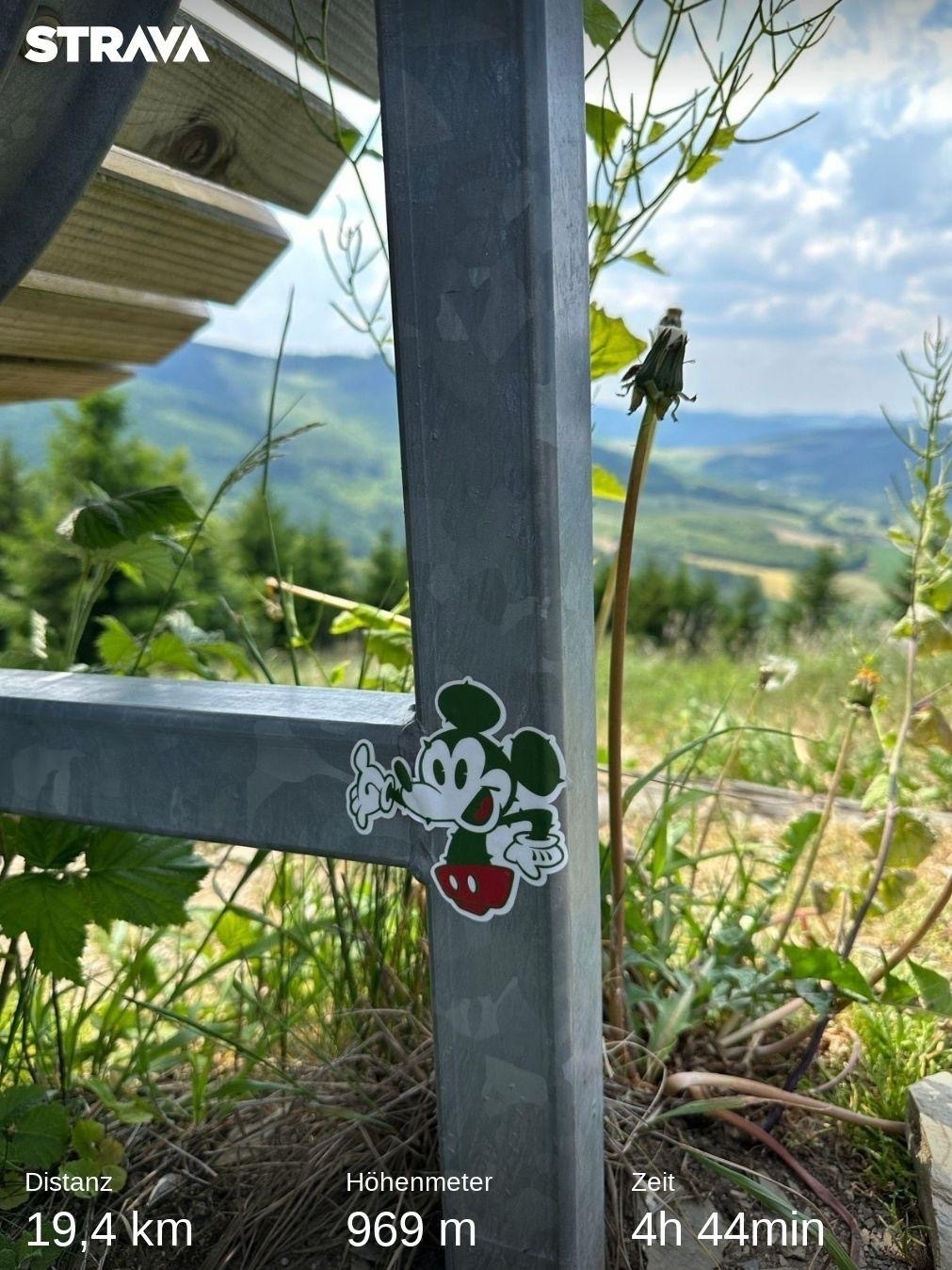 Mickey Mouse Sticker on bench with Strava statistics of the hike 