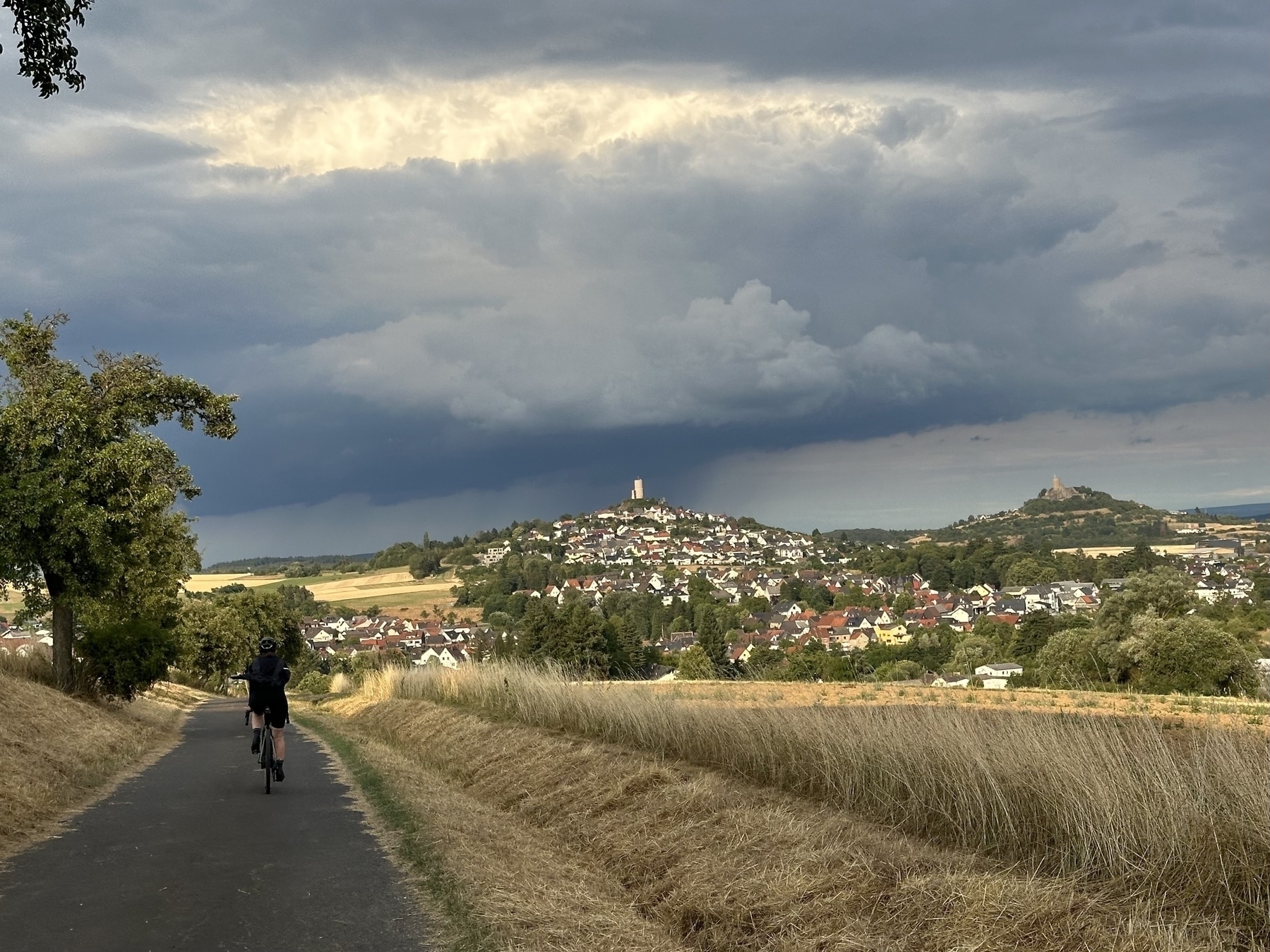 Cyclist, two castles and a rain front