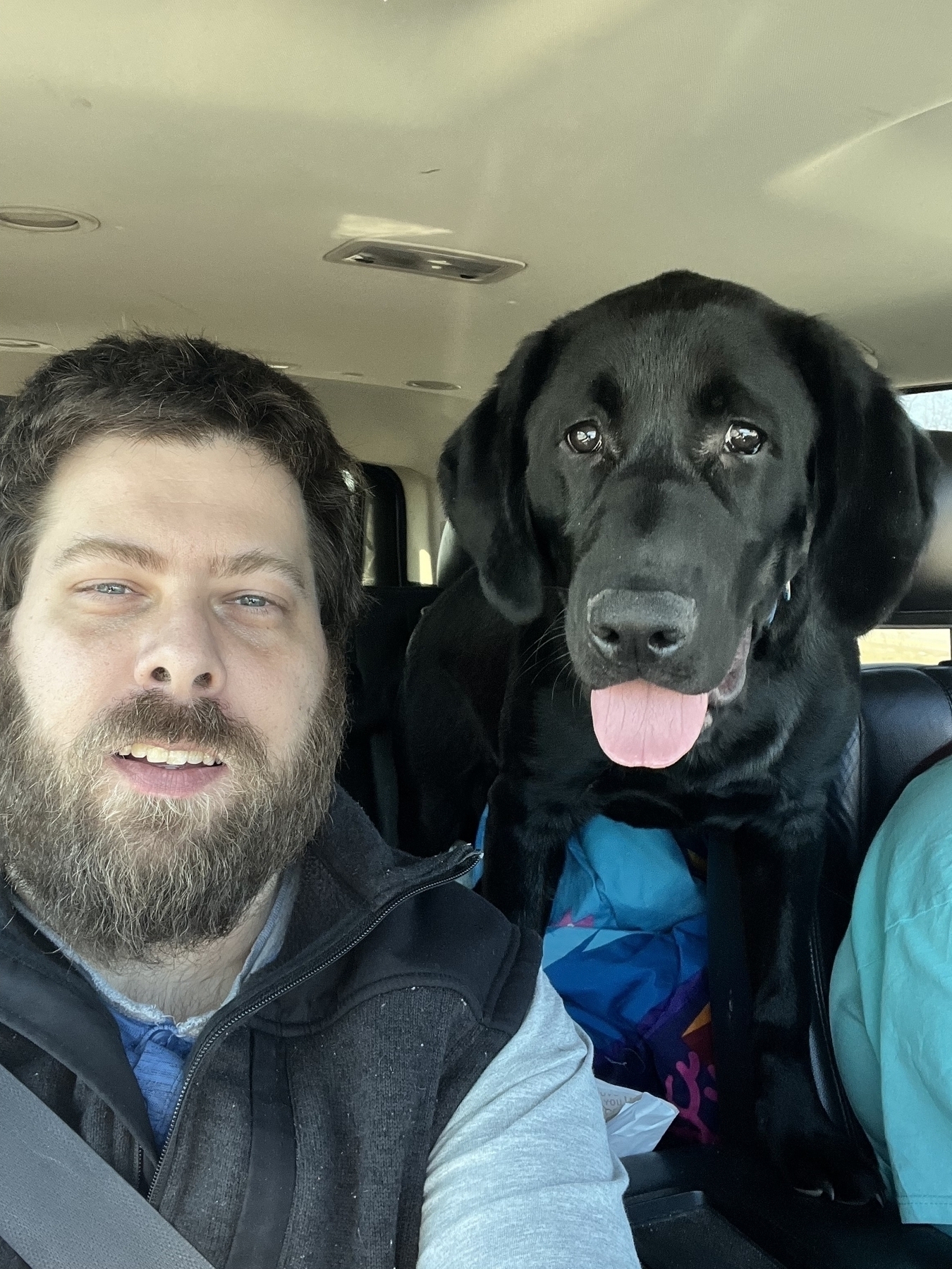 Person with a black lab dog