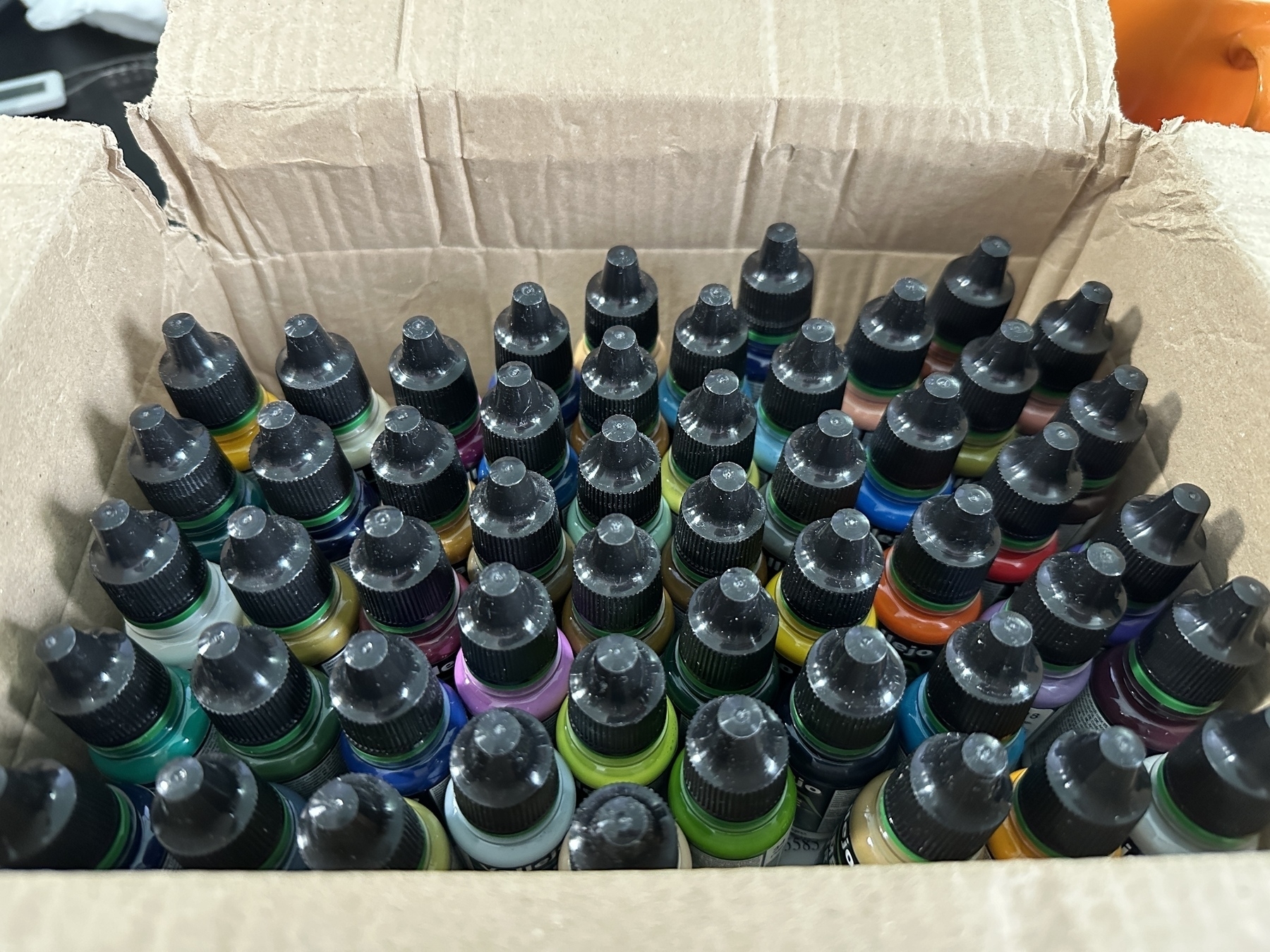 A cardboard delivery box containing 51 paints in various colours, from the new Vallejo Game Air miniature paint range