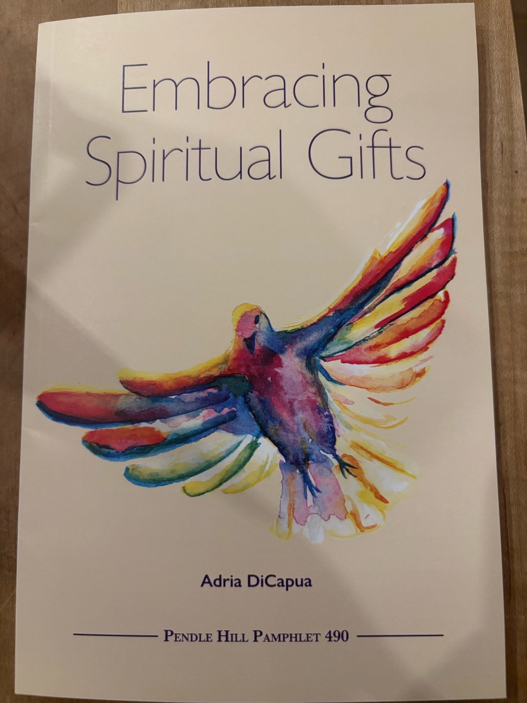 Pendle Hill Pamphlet #490 - "Embracing Spiritual Gifts" by Adria DiCapua, which is a slender, cream-colored pamphlet with an illustration of a purple bird with rainbow wing feathers