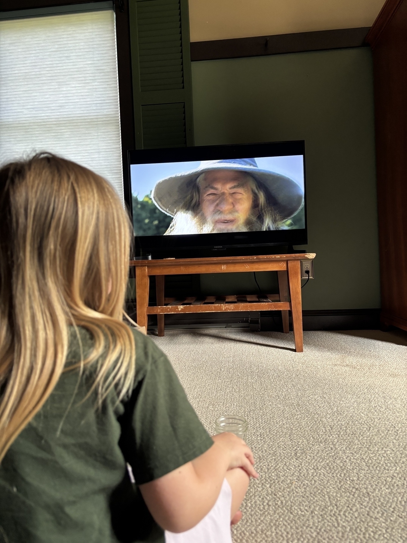 The same kid from the back again, this time staring at Gandalf’s smiling face.
