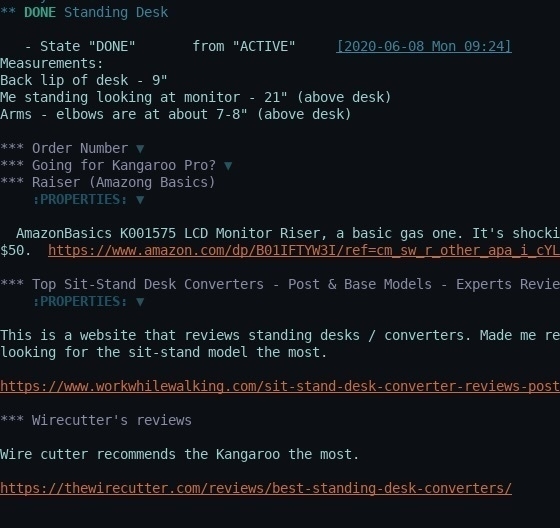 A task management interface in Emacs org-mode shows a completed task with notes on standing desk measurements and product recommendations.