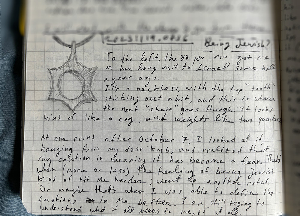 Auto-generated description: A close-up of handwritten text on lined paper, with a sketch of a necklace featuring a star-shaped pendant at the top left.