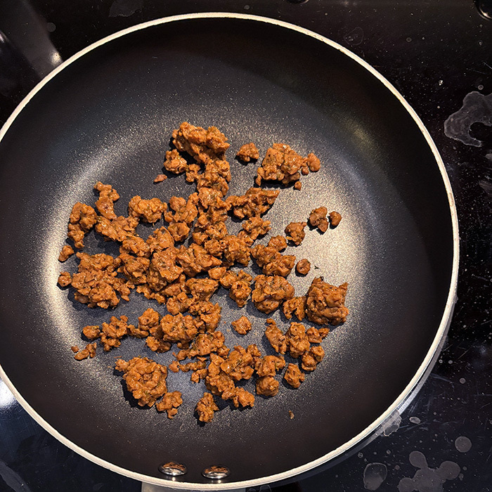 vegan ground meat (chorizo) in a frying pan.