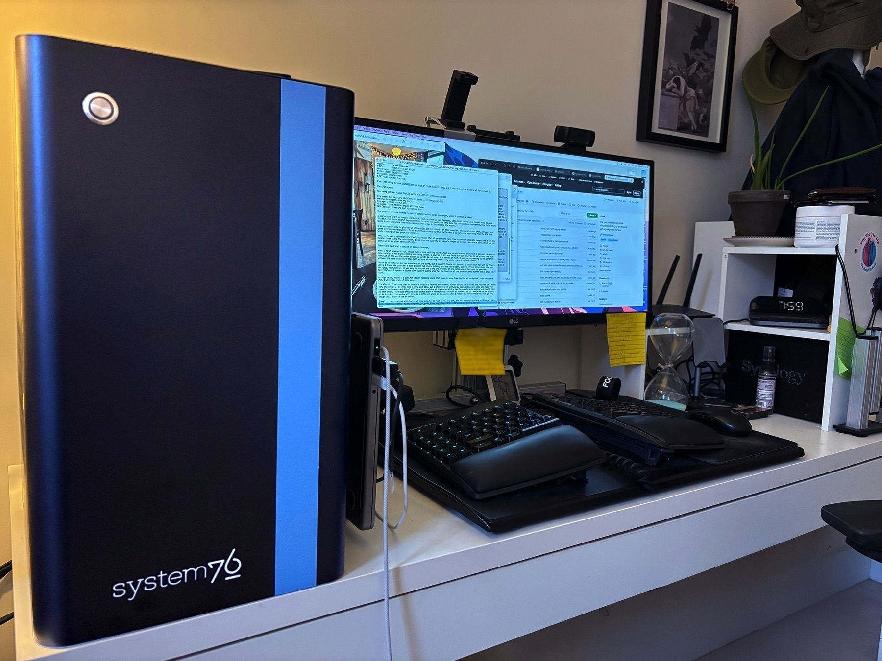 A desktop setup features a System76 Thelio Mira computer tower alongside a monitor displaying text and various desktop accessories.