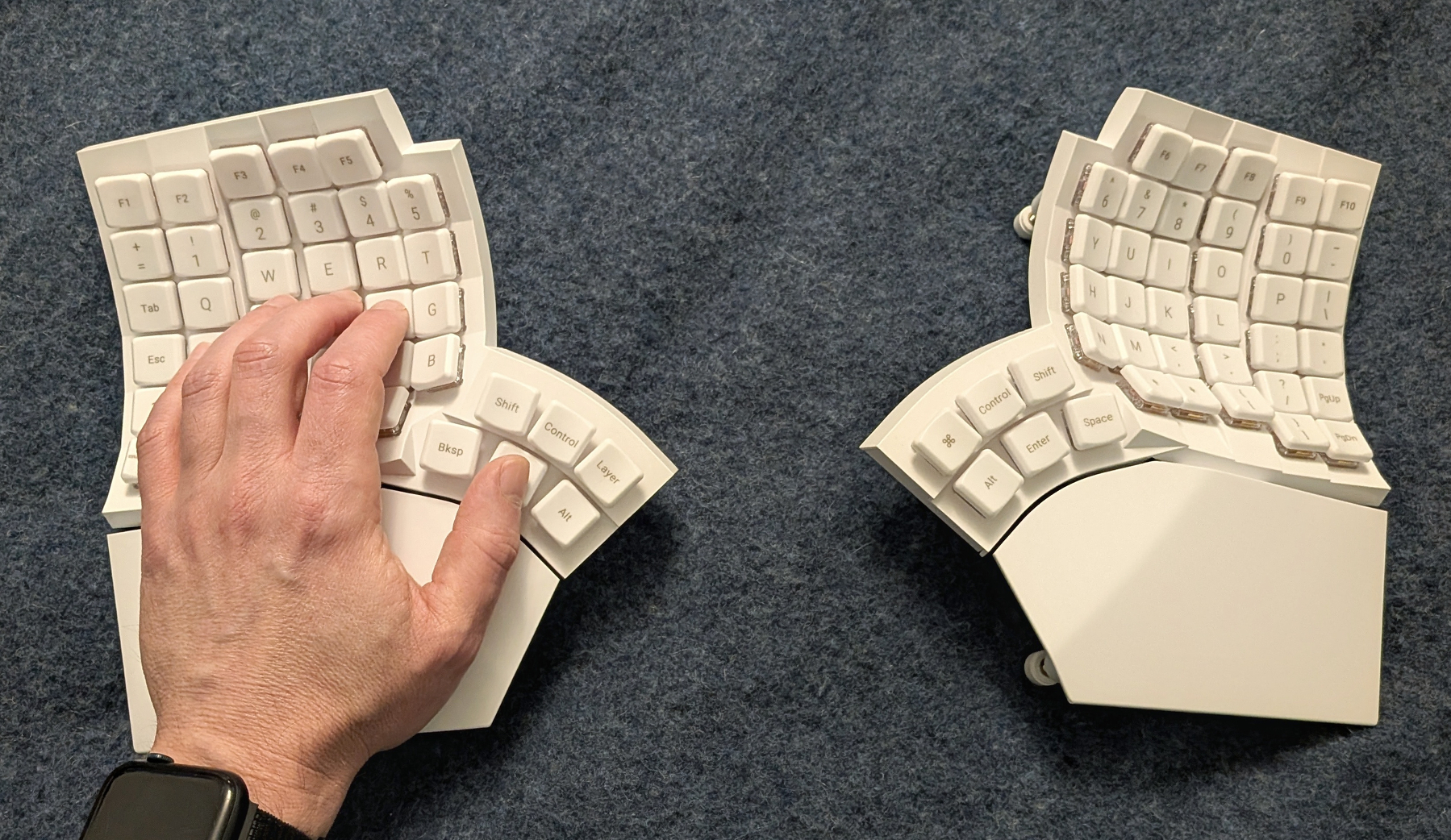 the glove80 keyboard parts show from the top, with a left hand positioned on the left part.