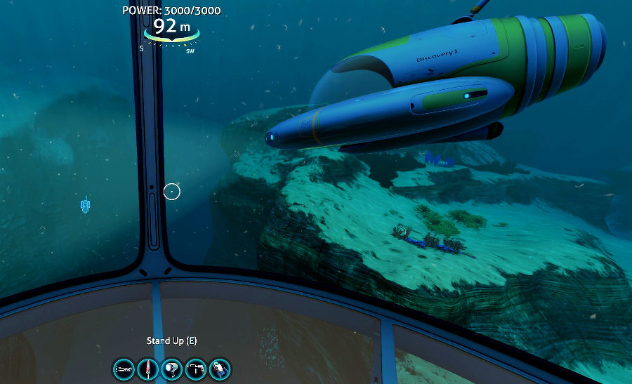 Auto-generated description: A futuristic underwater vehicle is navigating through a marine landscape, as viewed from inside another submersible, displaying various on-screen controls and information.