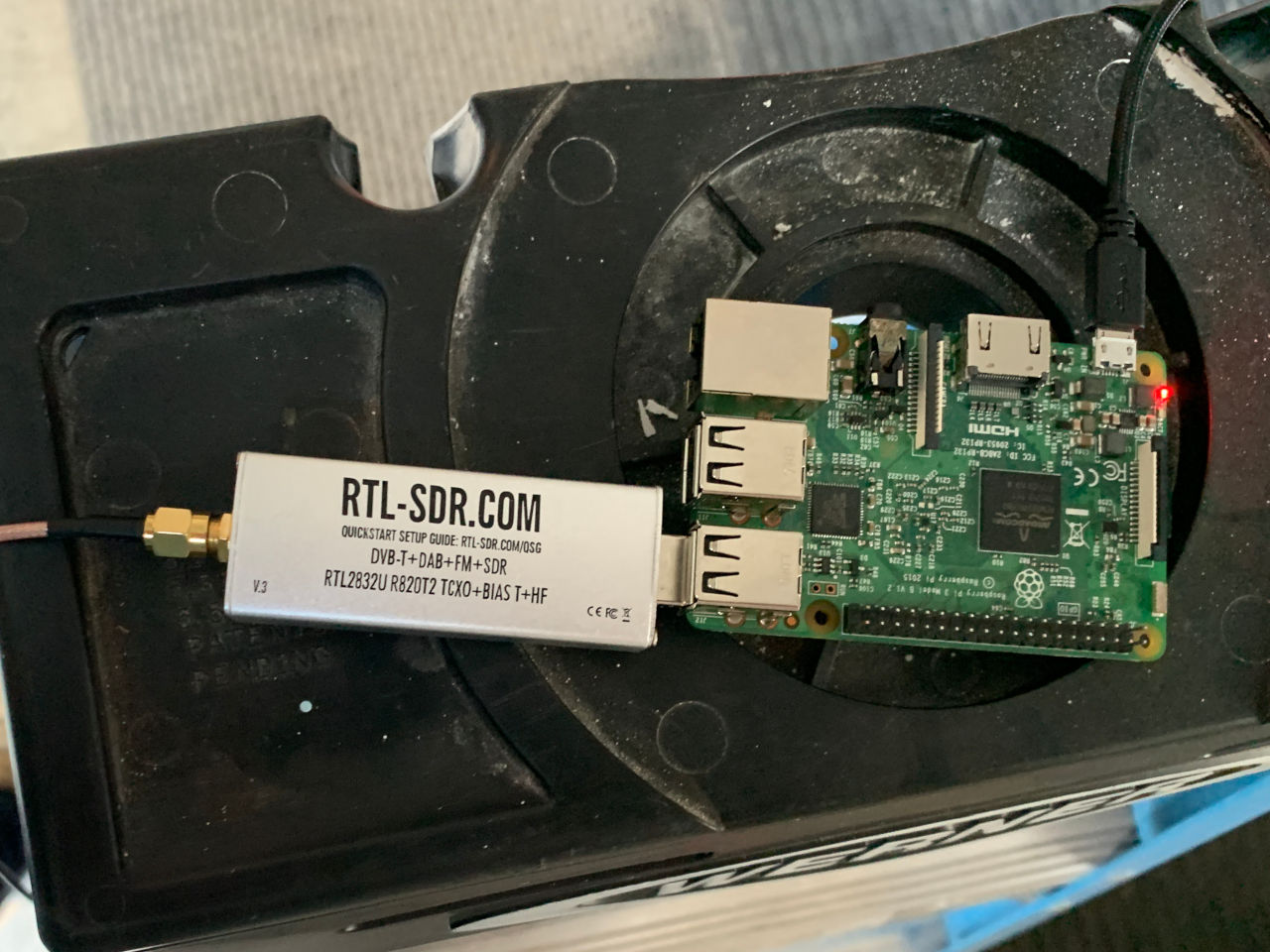 Photograph of a Raspberry Pi single board computer with an RTL-SDR software-defined radio attached.