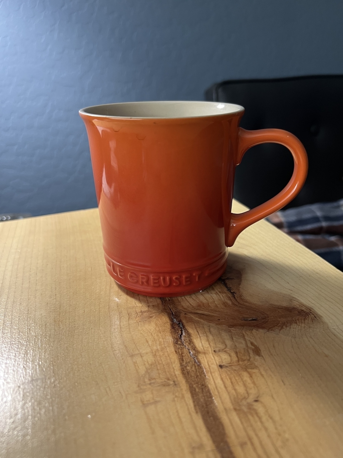 Orange coffee mug on side table