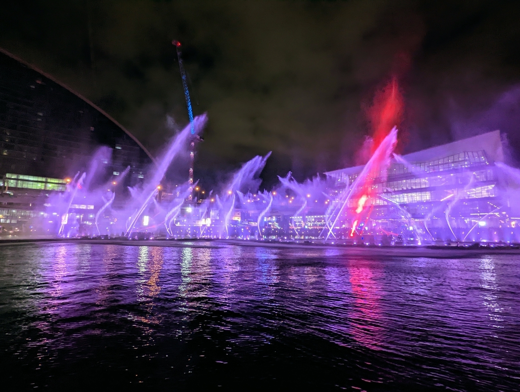 Huge jets of water lit up in purple at Darling Harbour, Sydney. 