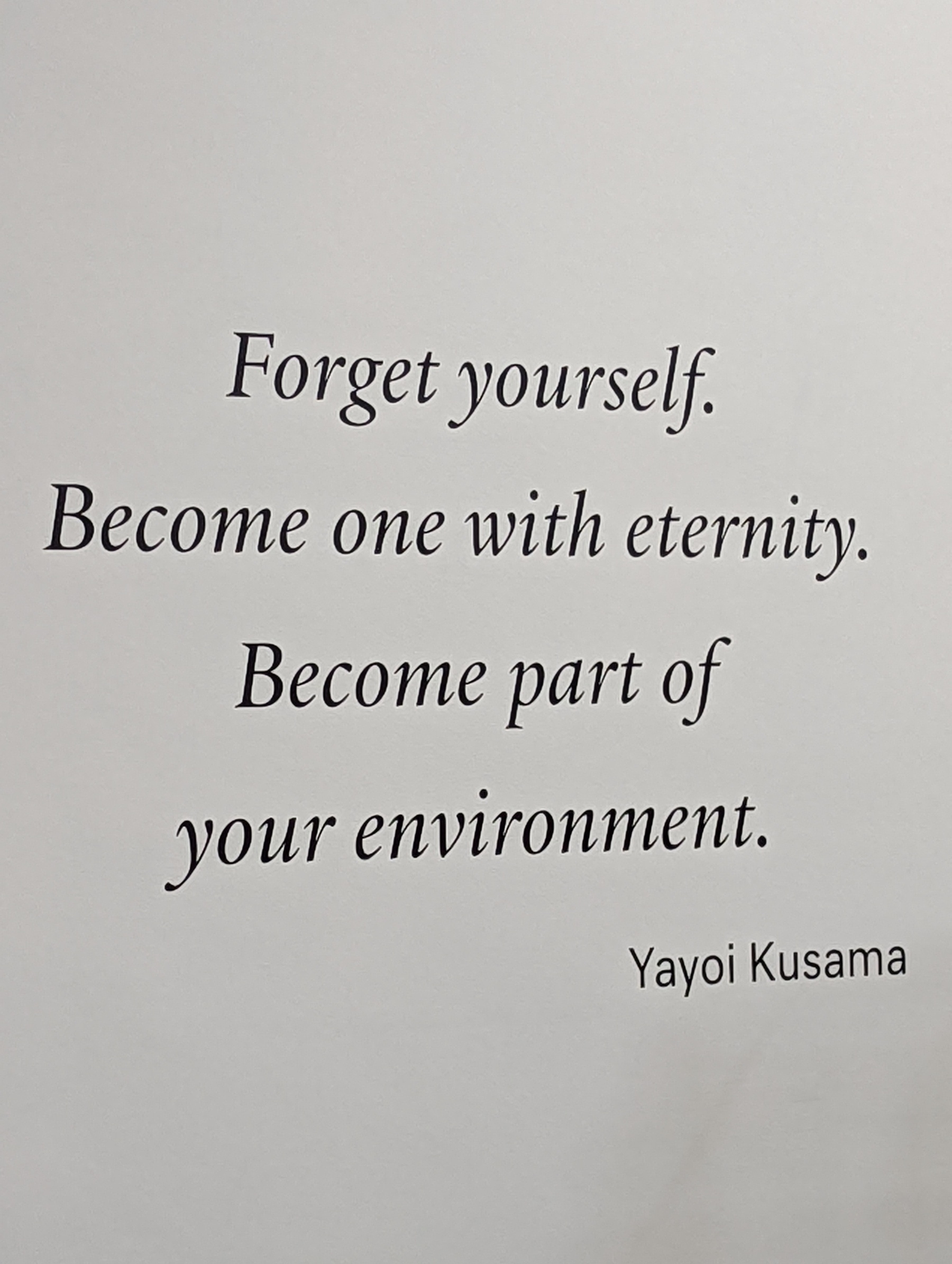A sign quotes the artist Yayoi Kusama: Forget yourself. Become one with eternity. Become part of your environment.