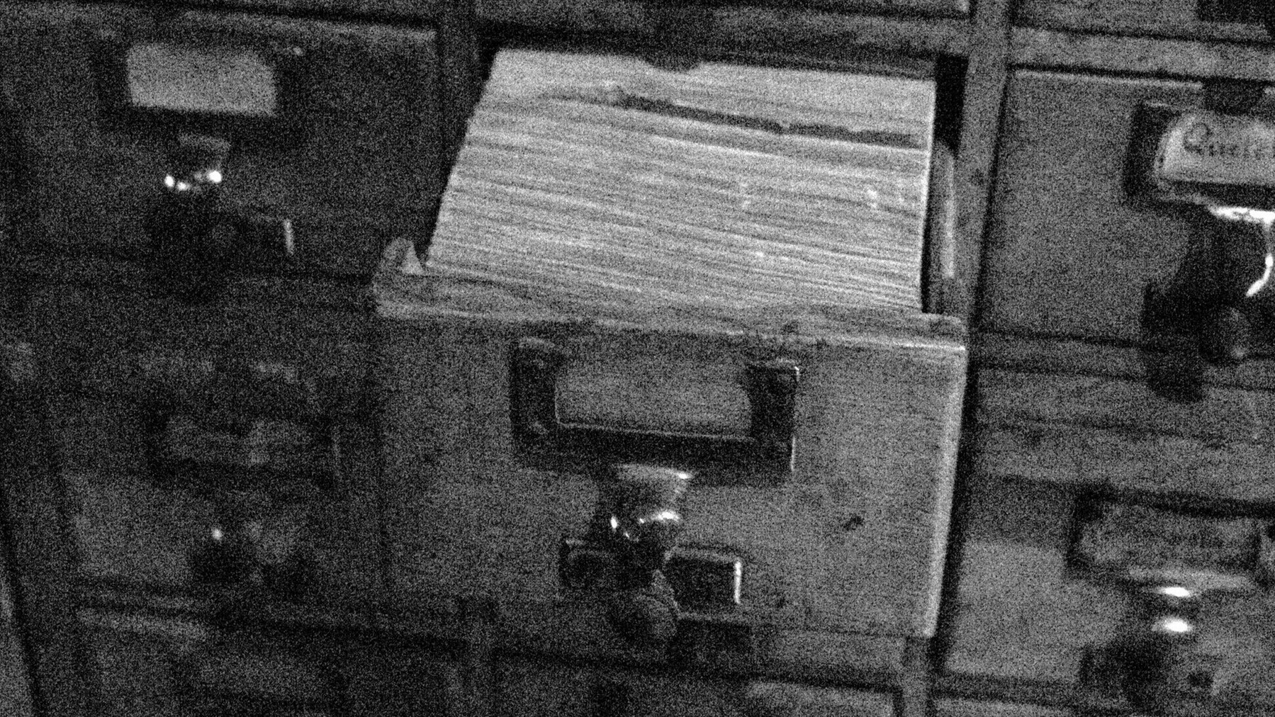 an open index card drawer in a large wooden catalogue