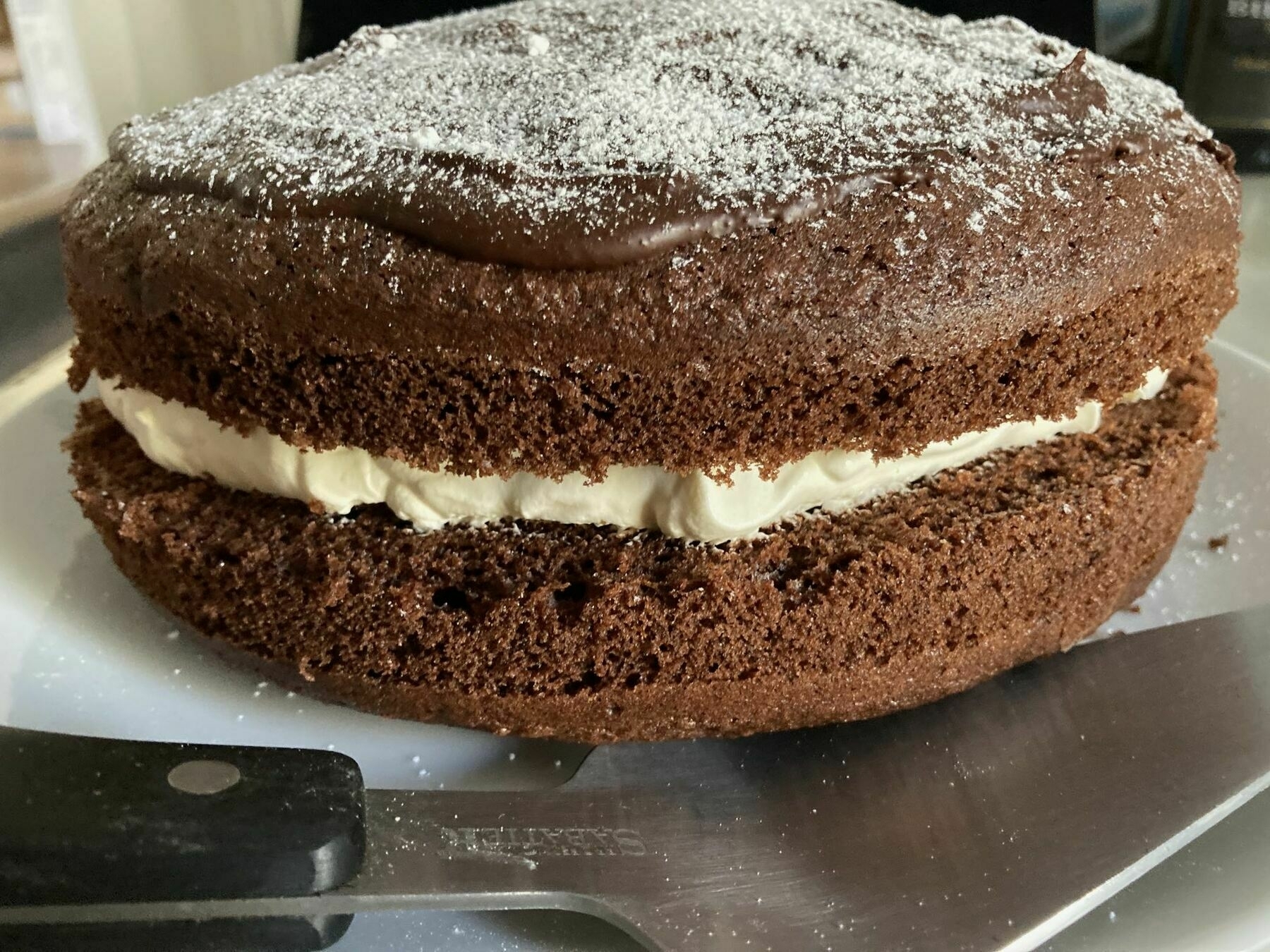 A chocolate cake with cream filling in the middle