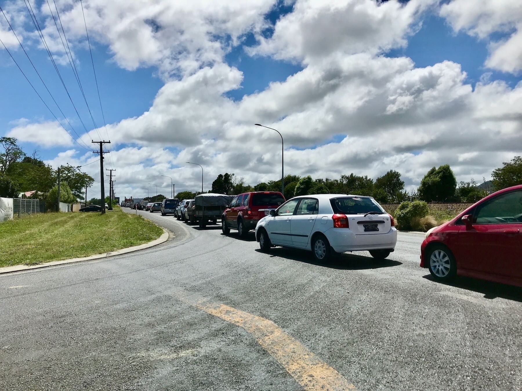 Cars stopped across an intersection. 
Traffic jam at the intersection, SH1 and Waikawa Beach Road, 05 February 2018. 
