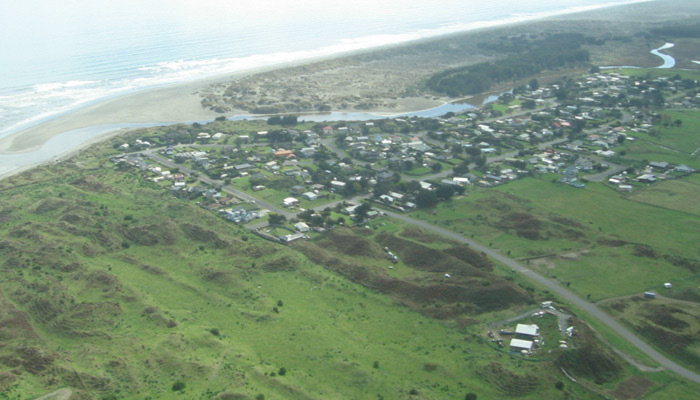 Aerial shot of Waikawa village, river and river mouth, looking northwest. 