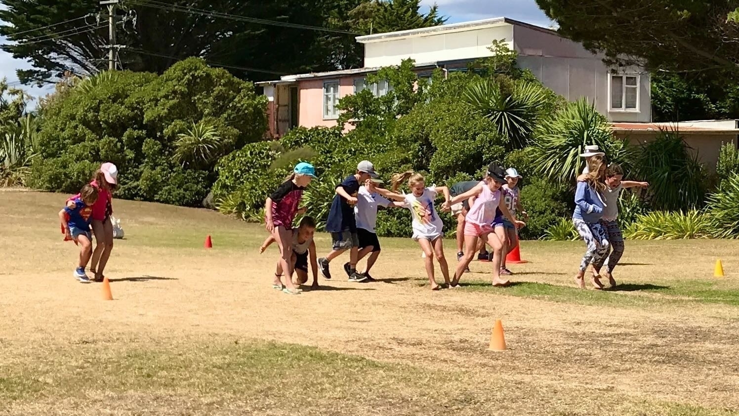 Children run a 3-legged race on Sports Day 2018. 