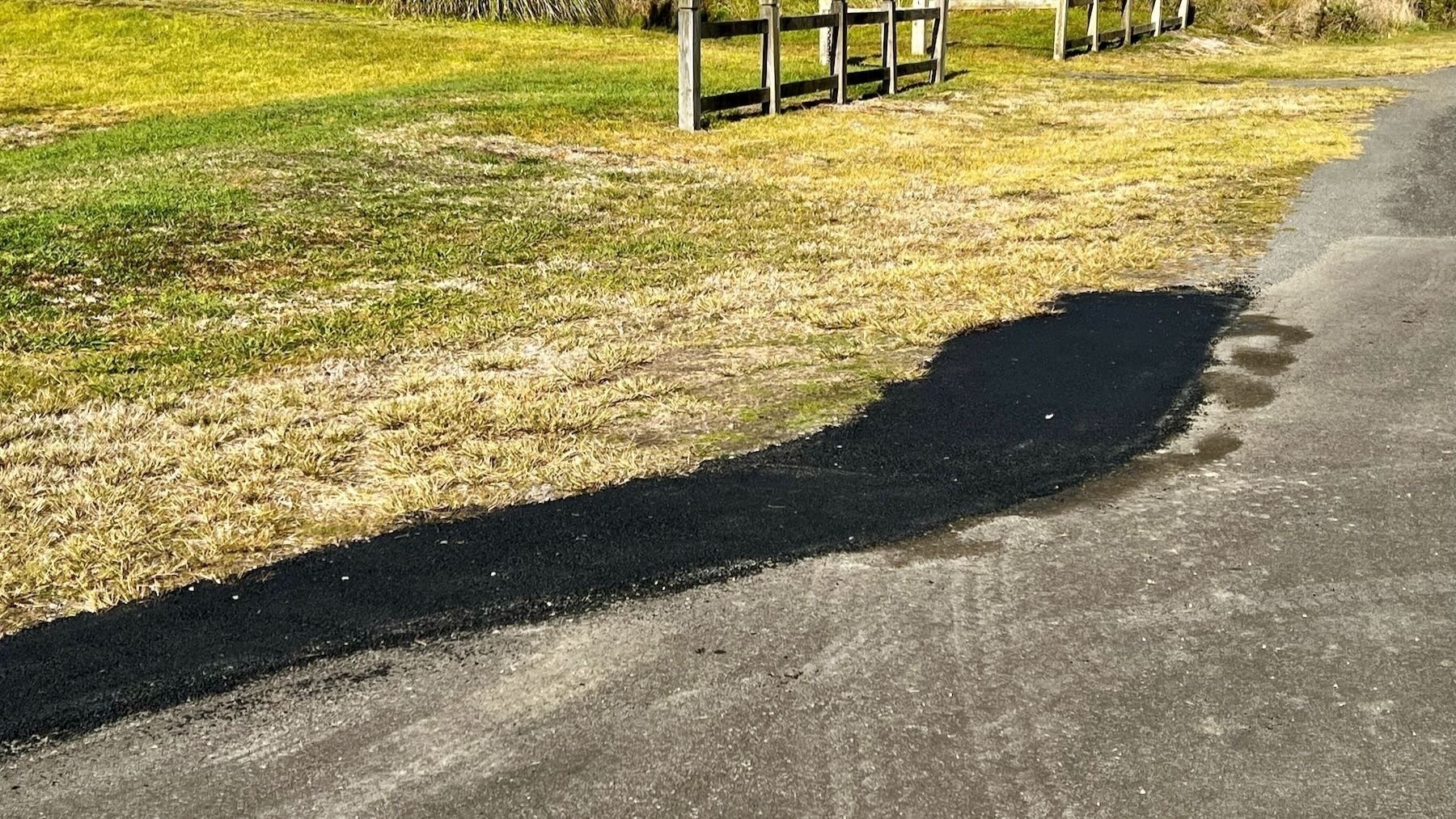 A fresh patch of tar seal beside the road. 