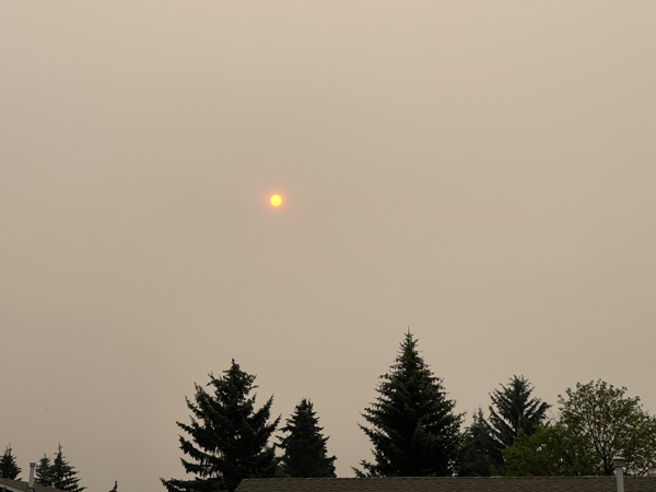 Morning sun partially obscured by smoke.