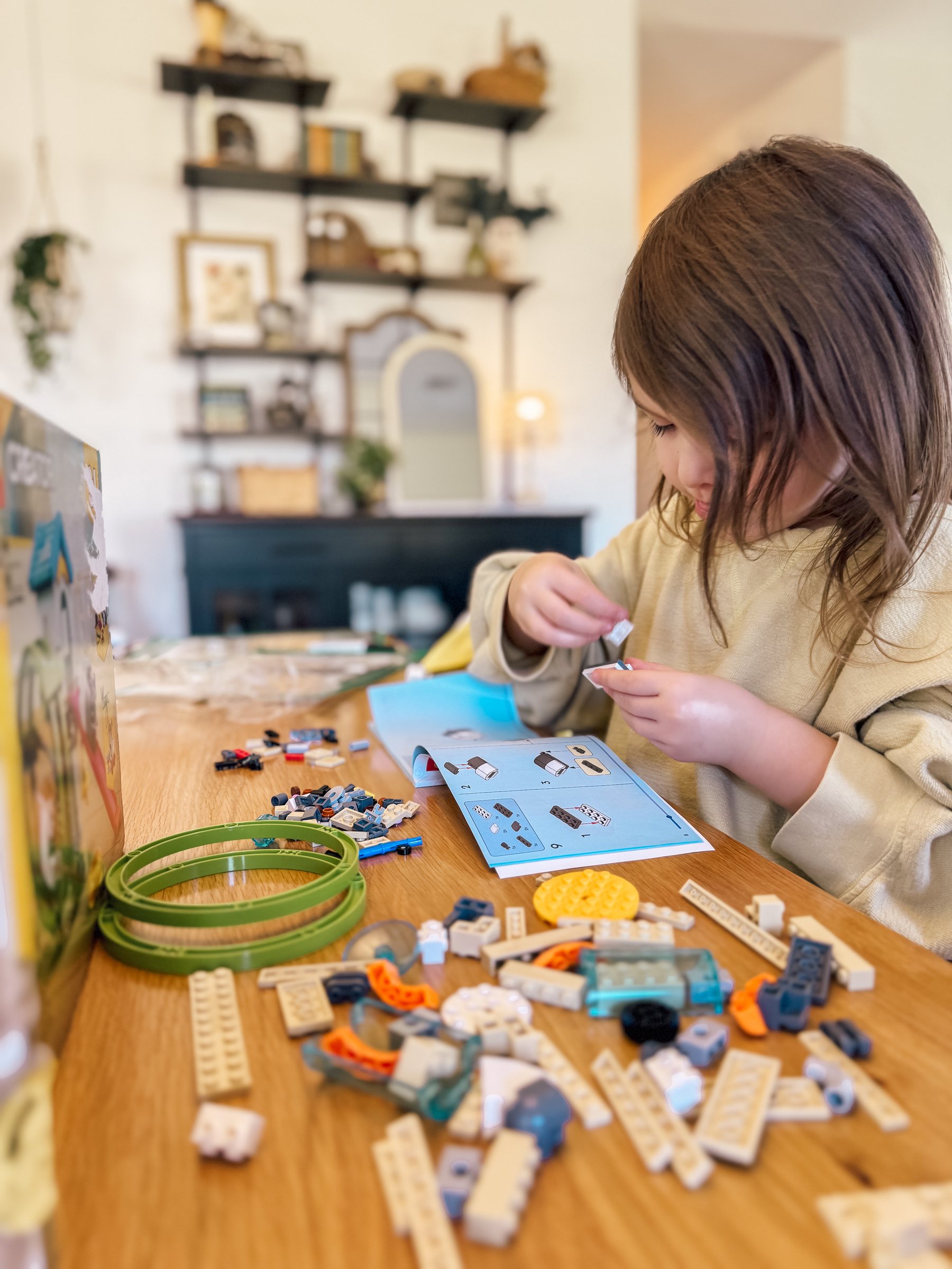 4-year-old girl putting together a Lego set
